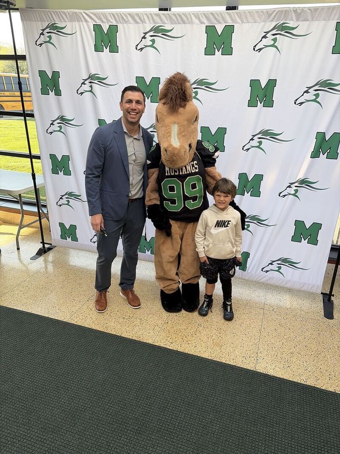 Dr. David Jacobs with his son and the Mainland Regional High School Mustang mascot during Bring Your Child to Work Day