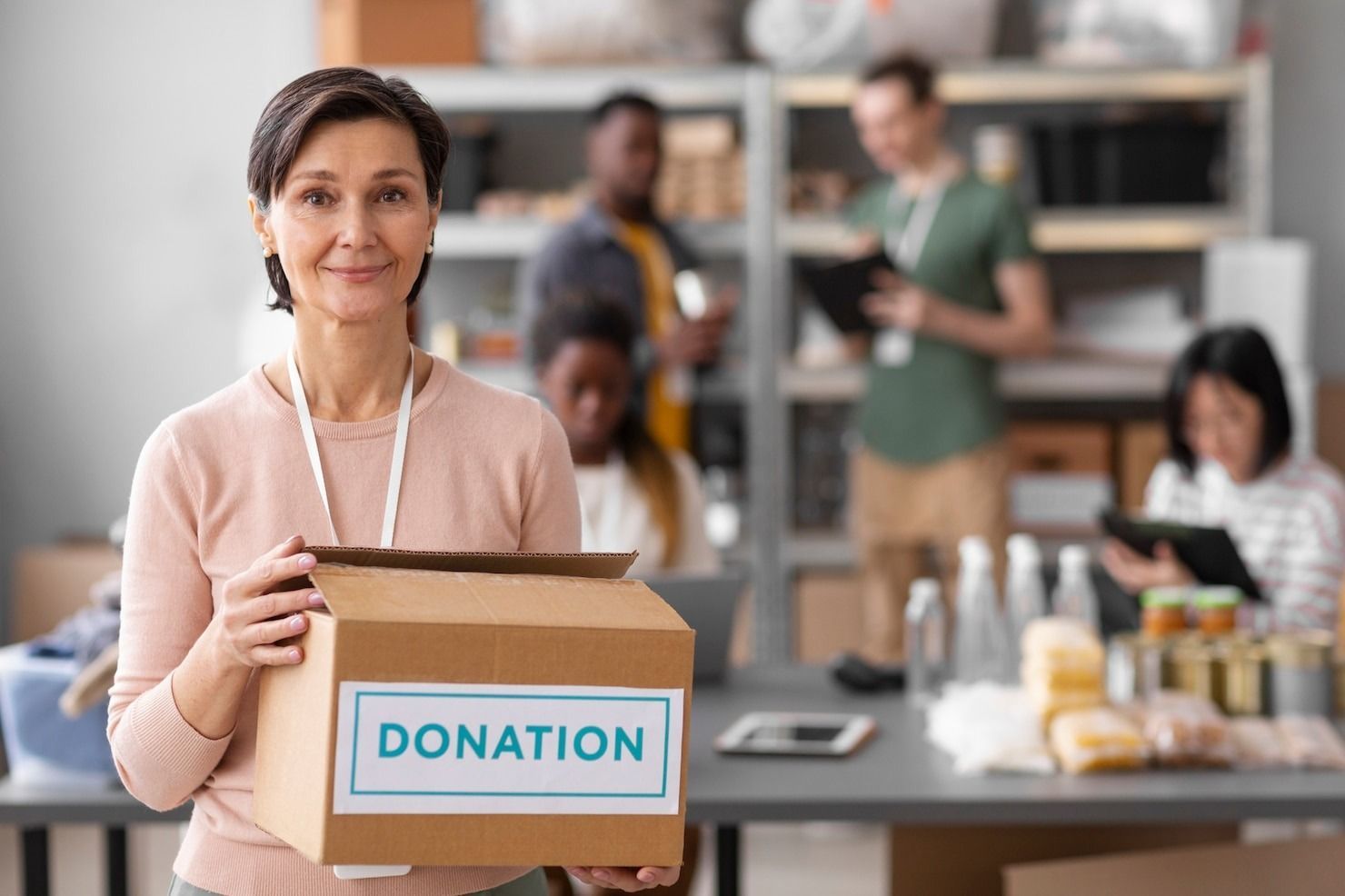 A person holding a cardboard box labeled