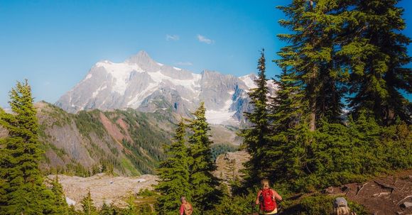 Tours to BC - Summer Golf - Winter Heli Ski BC Columbia mountain range in distance under sunny blue sky