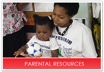 Woman and child holding a soccer ball;