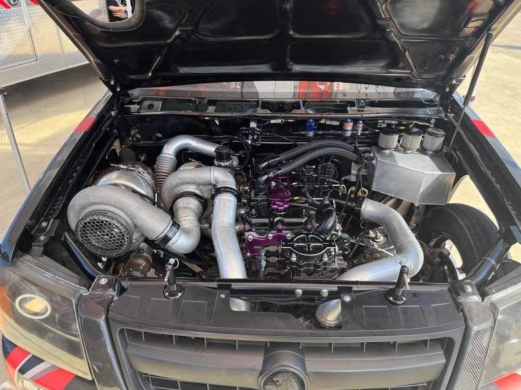 Black truck with the hood up and the engine visible - Mount Saint John, QLD - Cutlers Diesel Performance