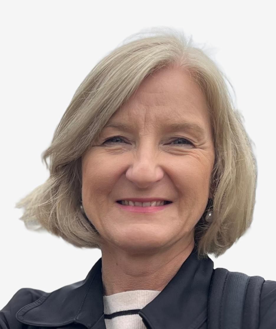 Smiling woman with short blonde hair wearing a dark jacket against a white background