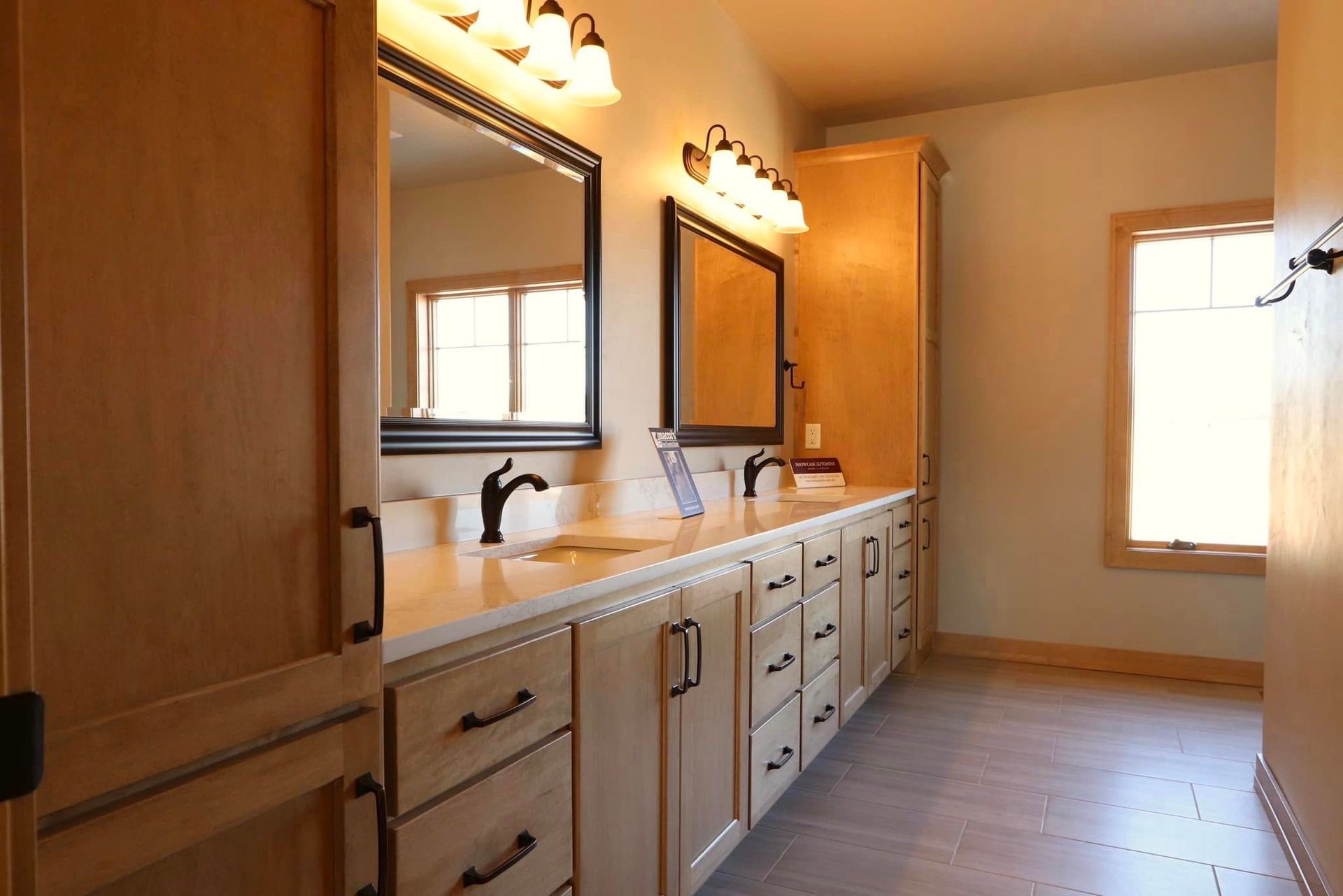 A bathroom with two sinks and two mirrors