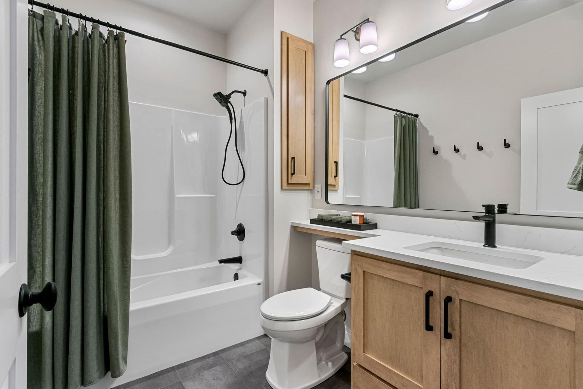 A bathroom with a toilet , sink , and mirror.