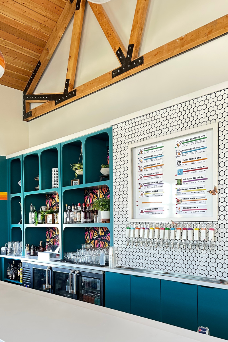 A kitchen with blue cabinets and a menu on the wall.