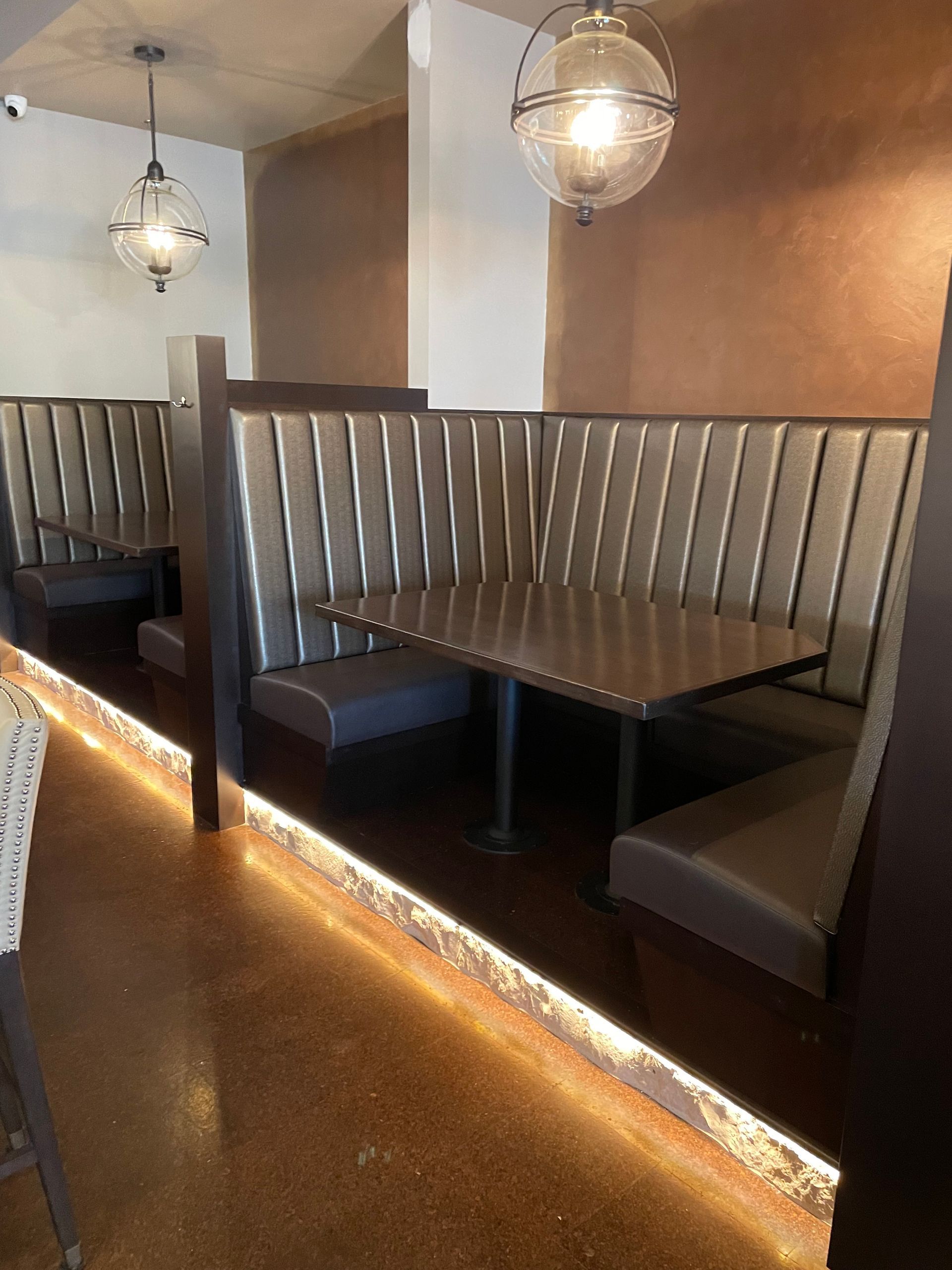 A row of booths with tables in a restaurant
