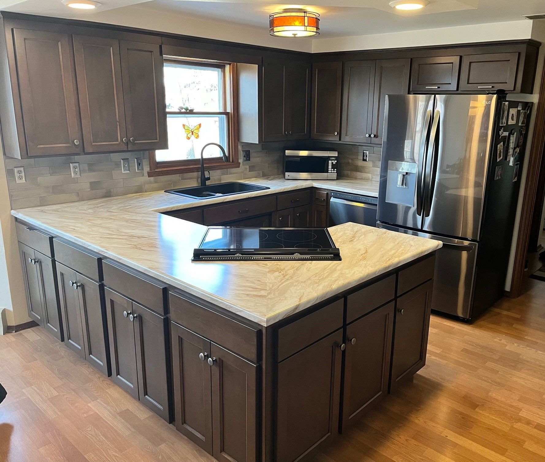 A kitchen with a large island and stainless steel appliances