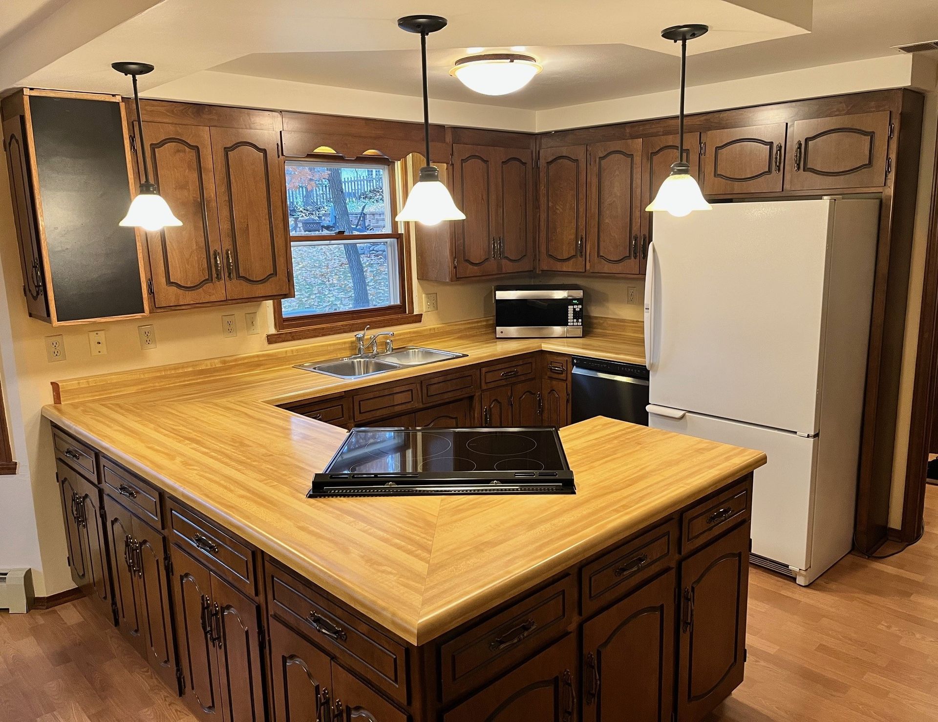 A kitchen with wooden cabinets and a white refrigerator