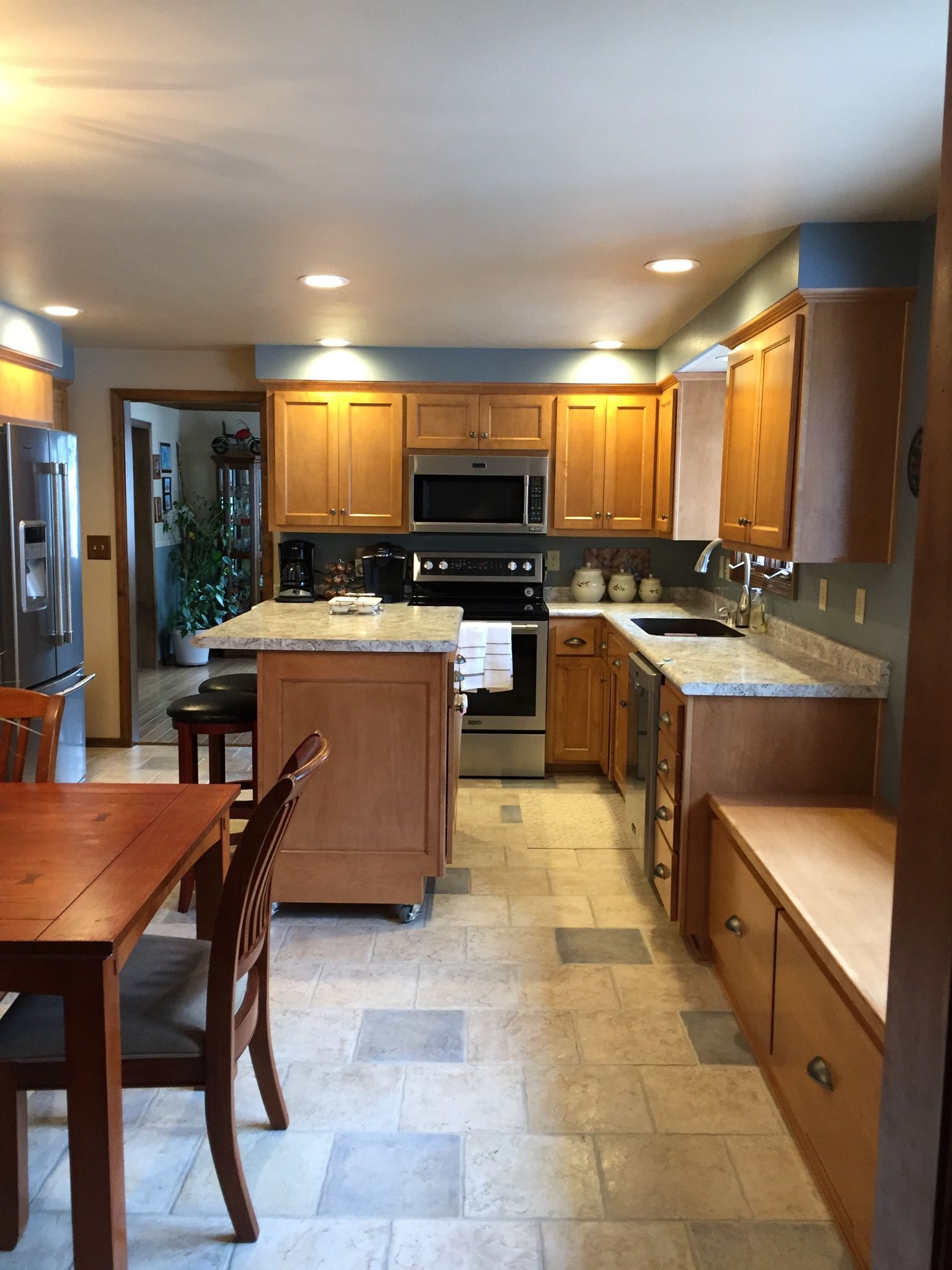 A kitchen with wooden cabinets and stainless steel appliances