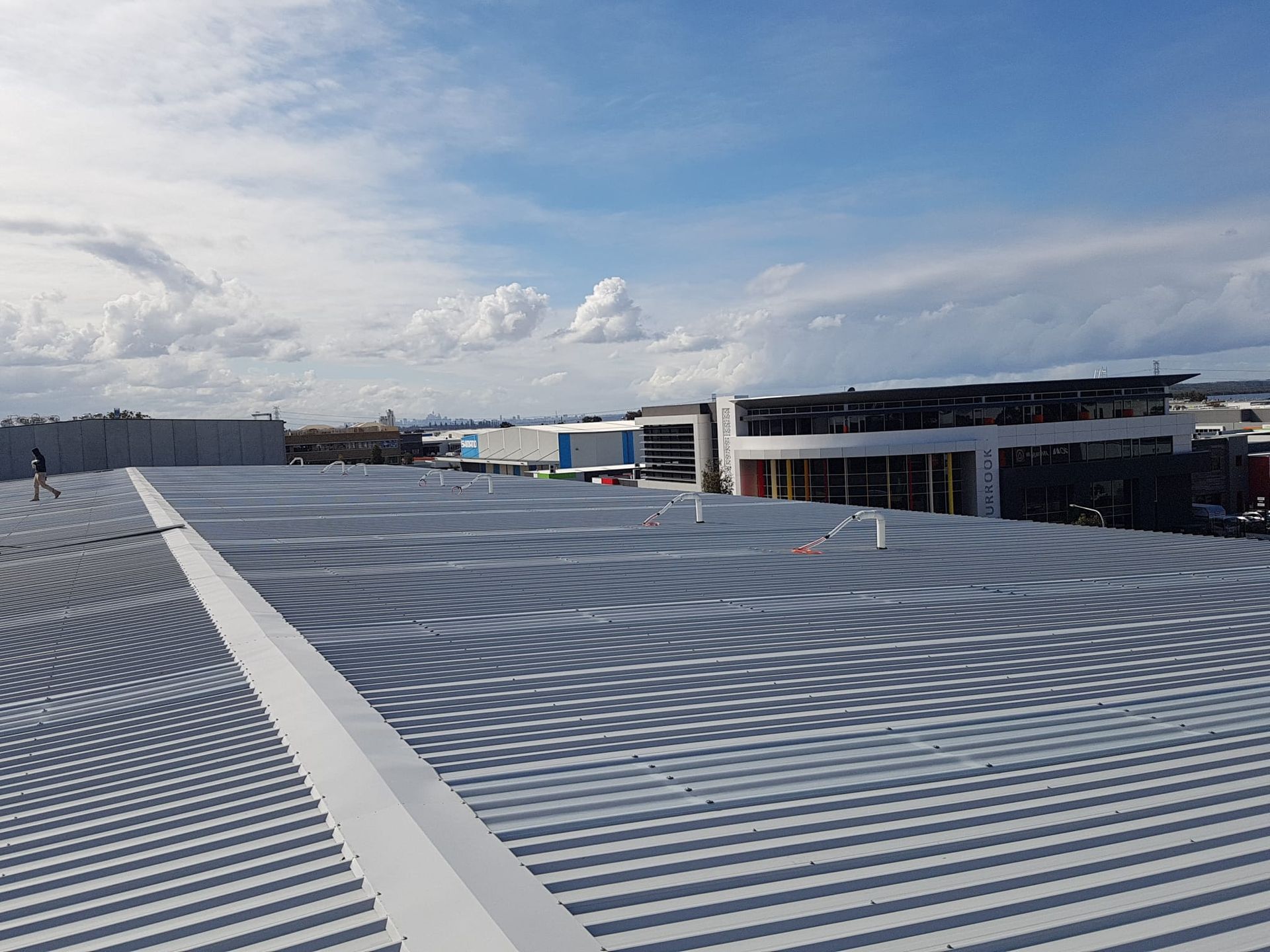 A large roof of a building with a blue sky in the background.