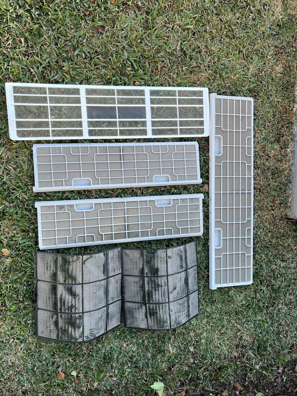 A person is cleaning the filter of an air conditioner.Blank