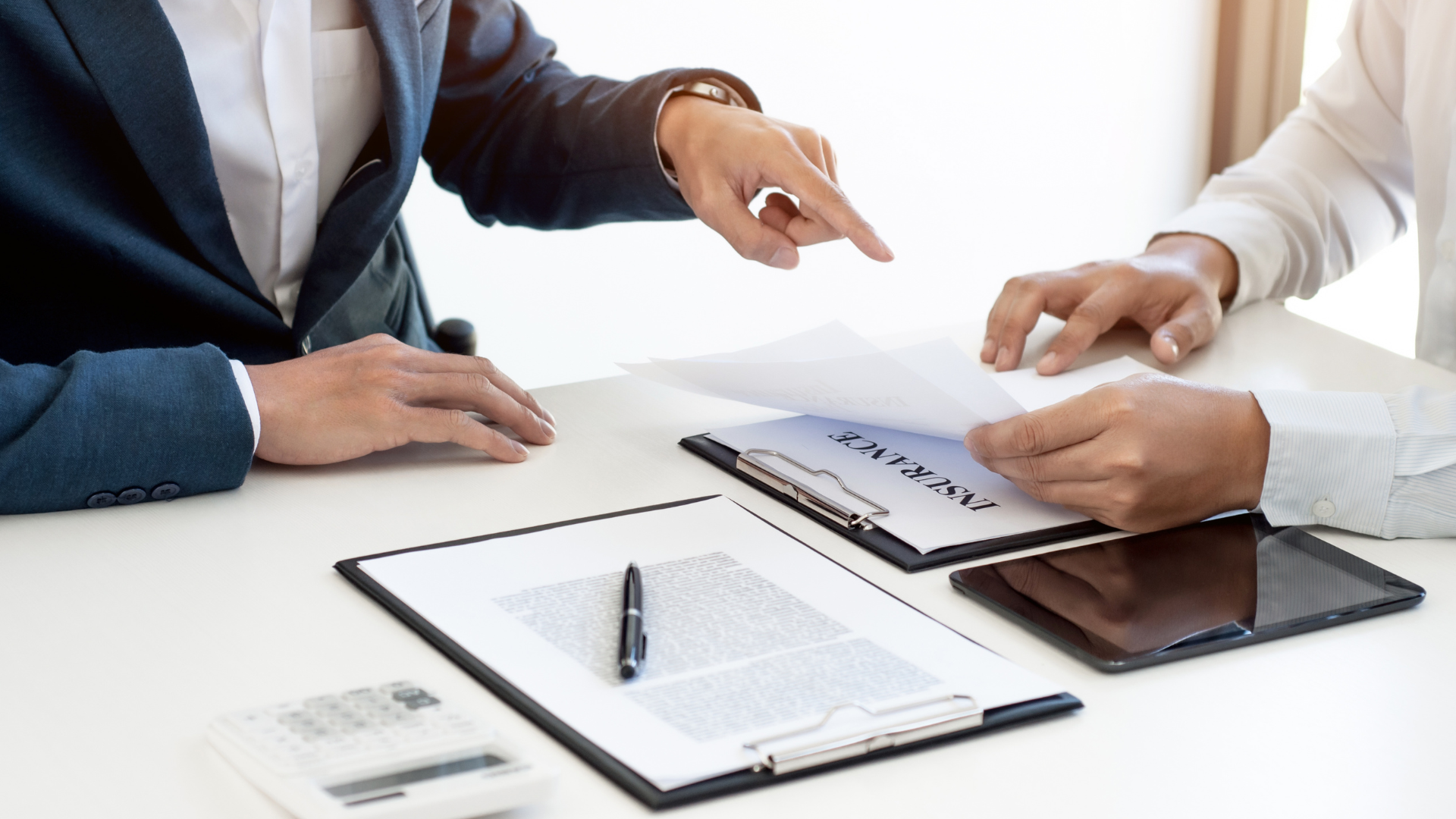 Two people are sitting at a table looking at a piece of paper.