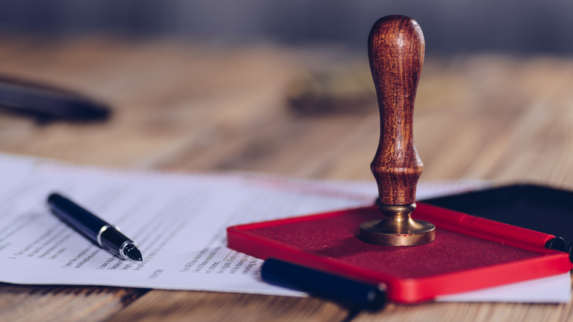 A notary stamp and pens on official documents, symbolizing notary services and document authenticati