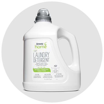 A bottle of laundry detergent is sitting on a white surface.
