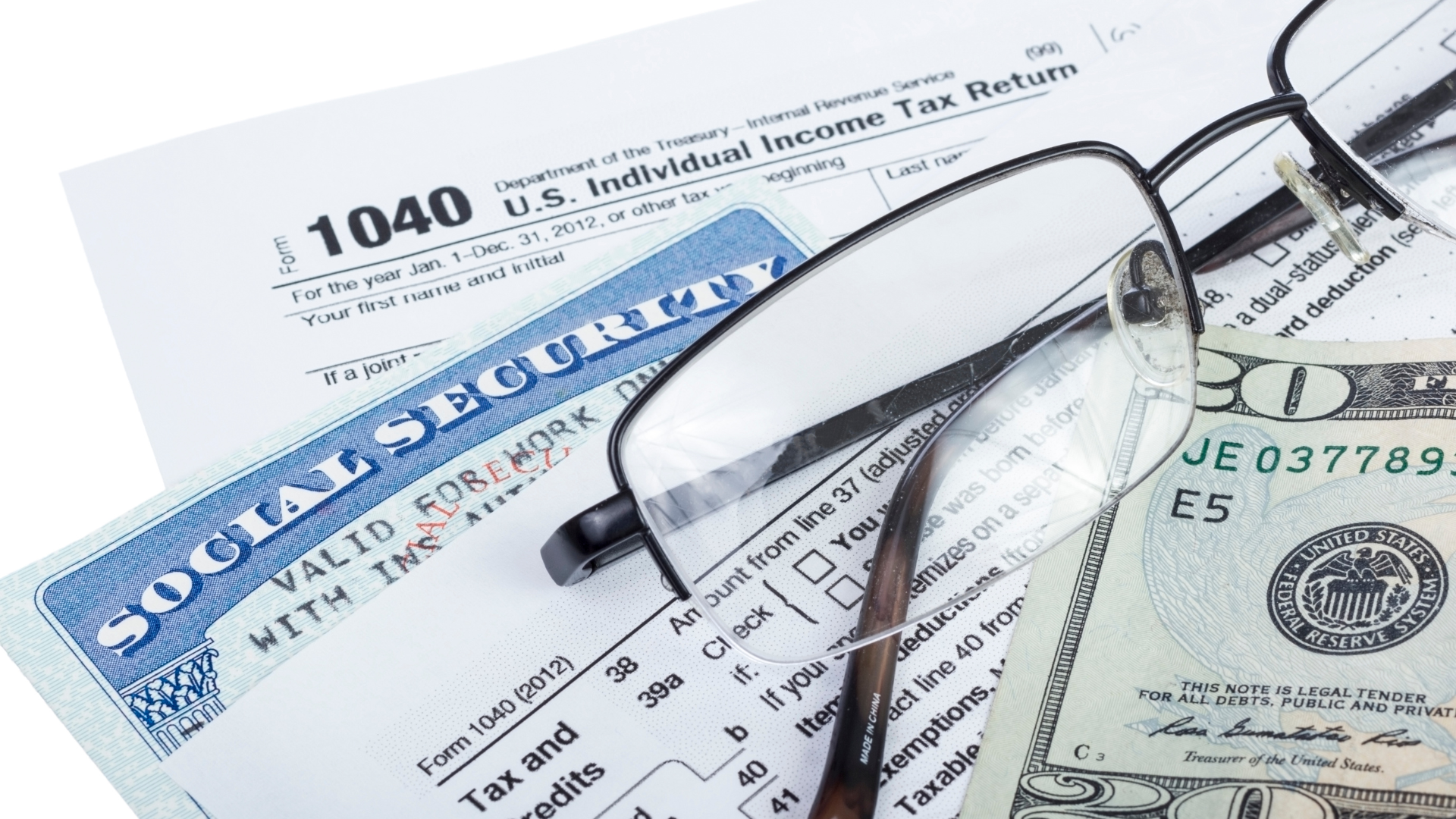 A pair of glasses sitting on top of a 1040 form