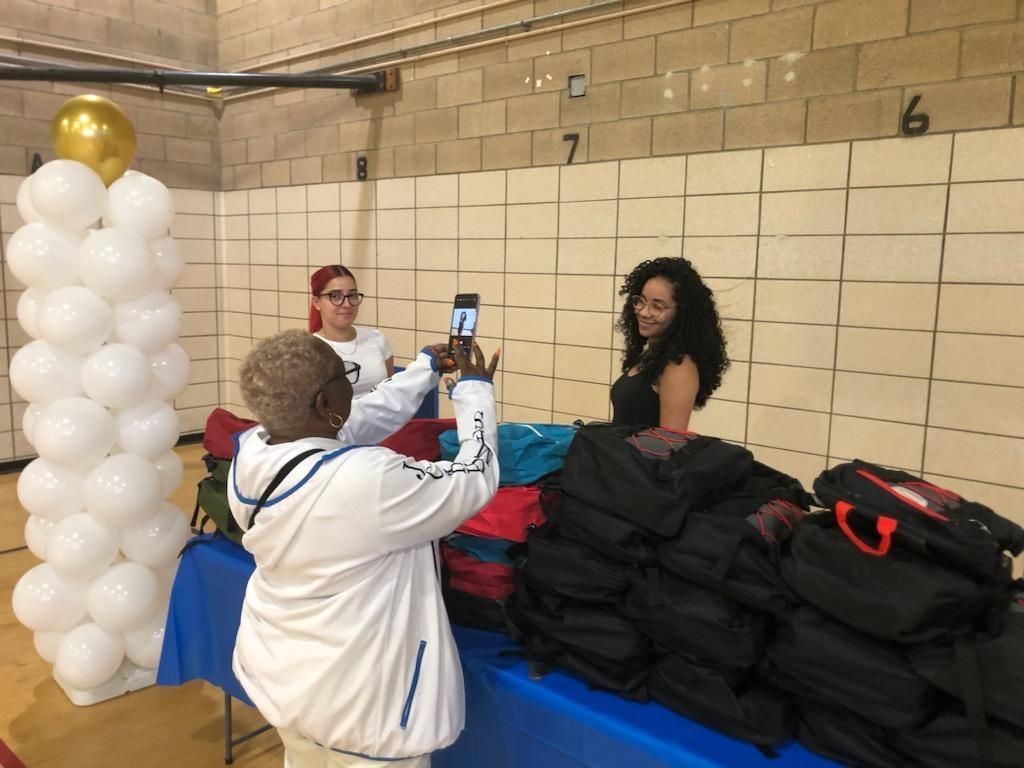 A man is taking a picture of a woman with a cell phone.