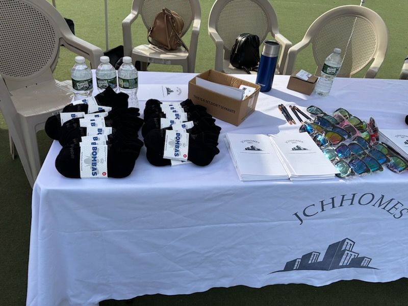 Table with merchandise, water bottles, and brochures, with 