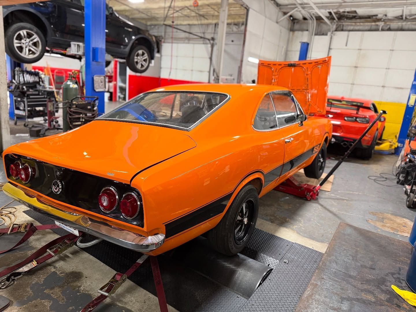 Classic Orange Muscle Car In Auto Repair Shop Bay | MLV Motoring