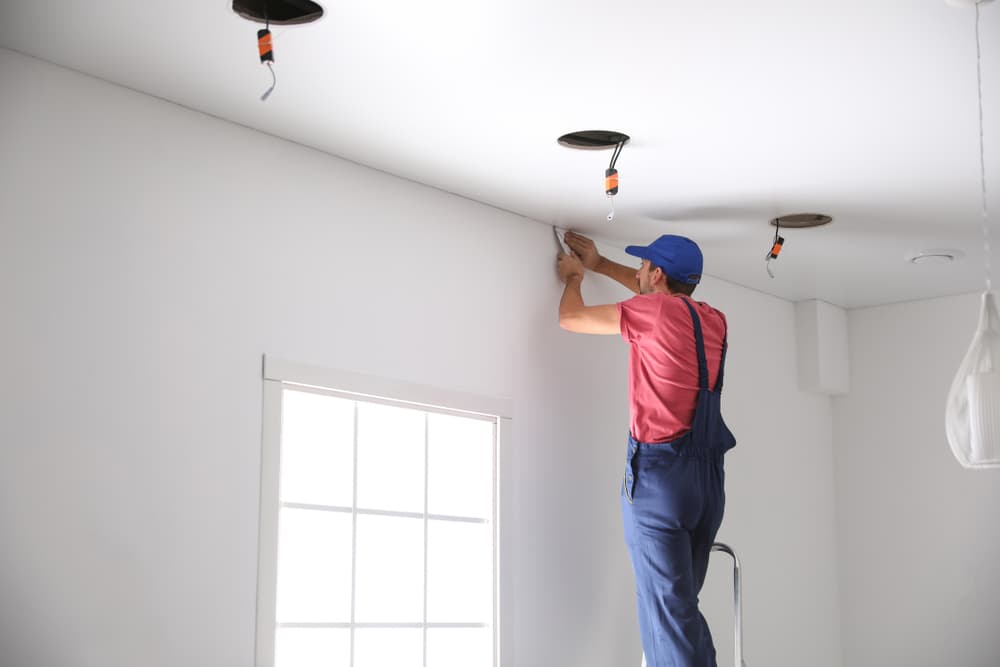 Electrician Installing Ceiling Lights — Experienced Electrician In Port Stephens, NSW