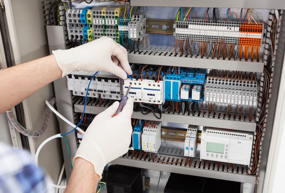 Electrician Wiring a Switchboard — Experienced Electrician In Port Stephens, NSW