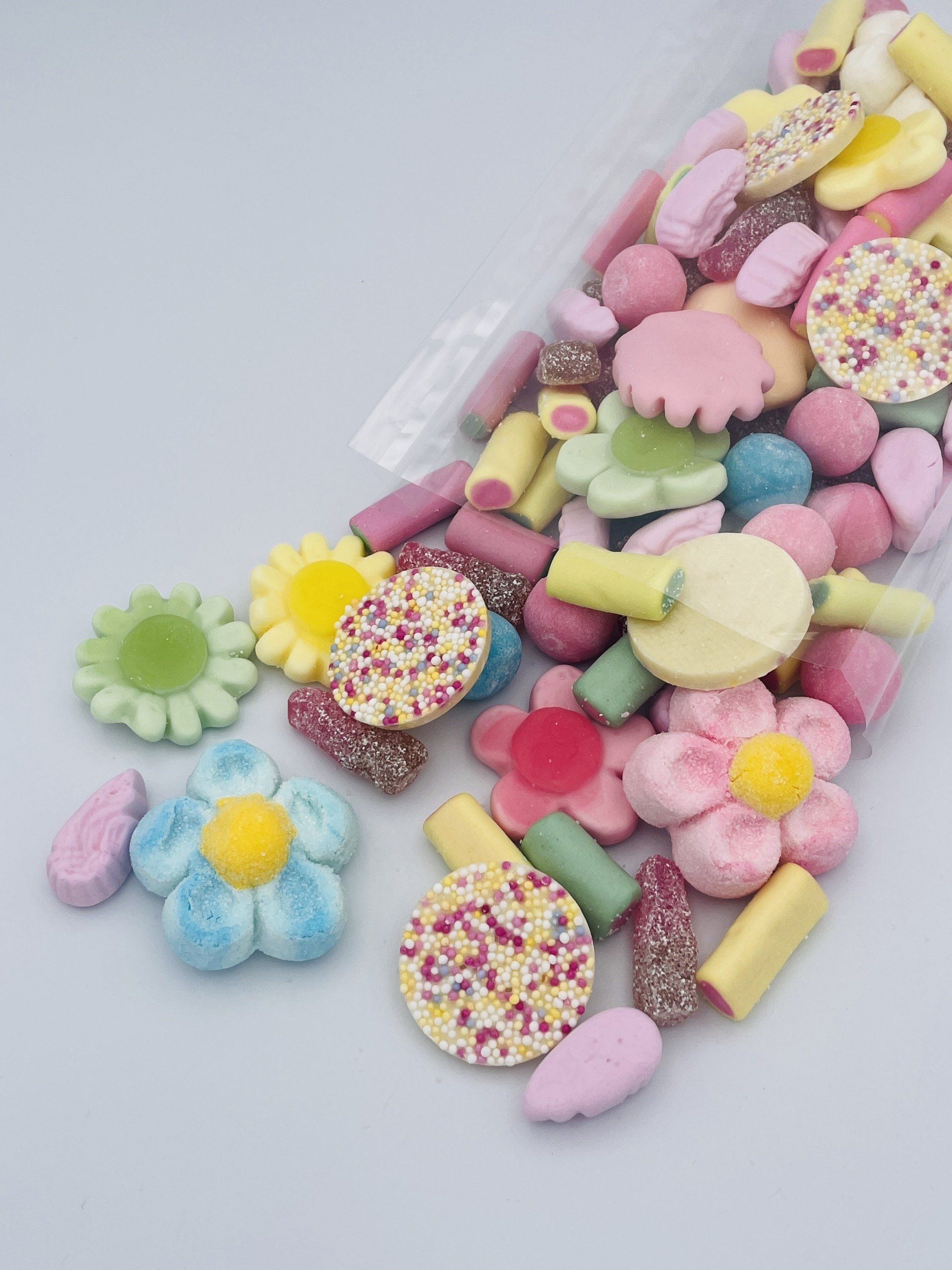 A plastic container filled with different types of candy