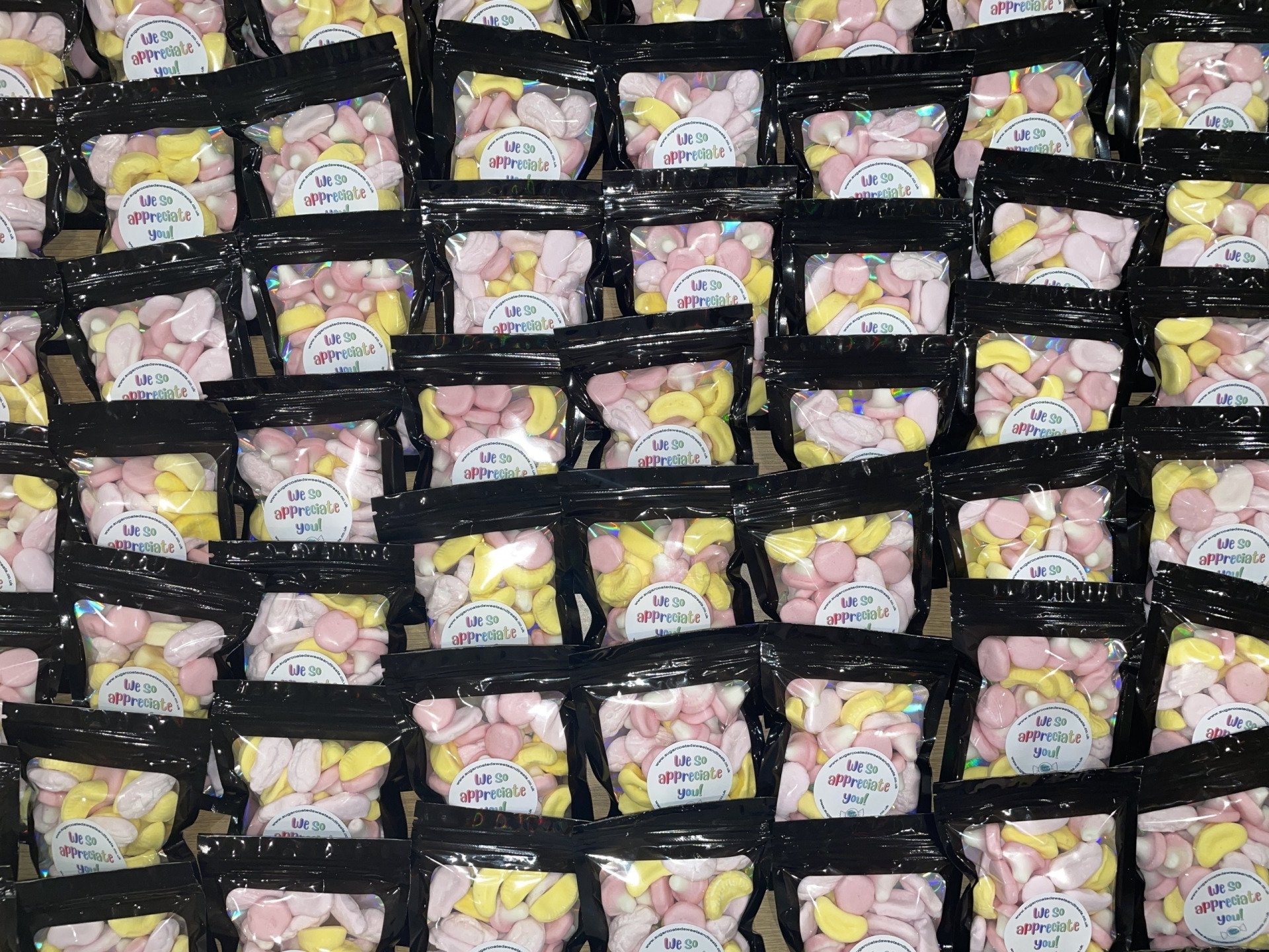 A bunch of bags of marshmallows are lined up on a table