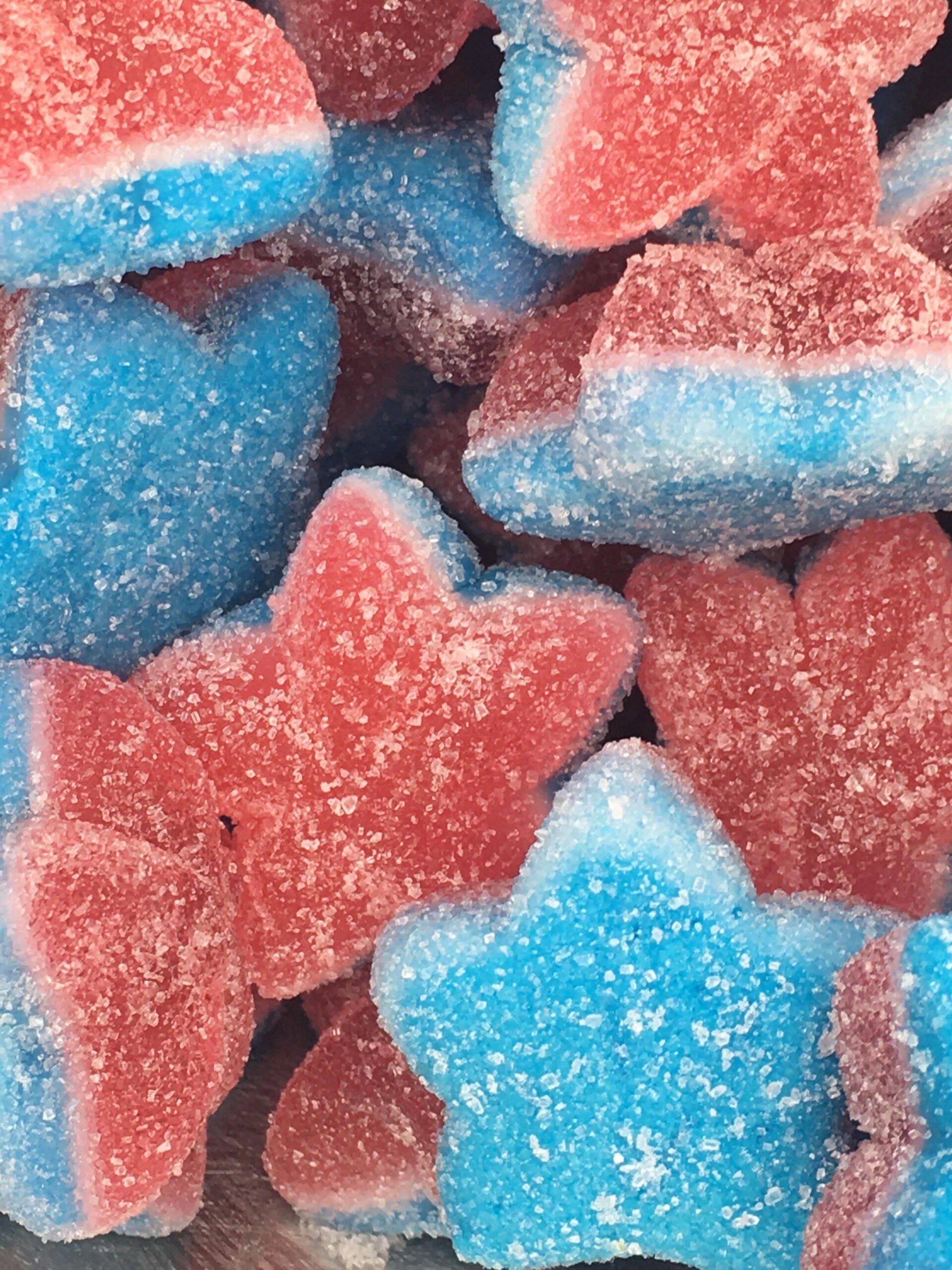 A pile of red and blue star shaped gummy candies.