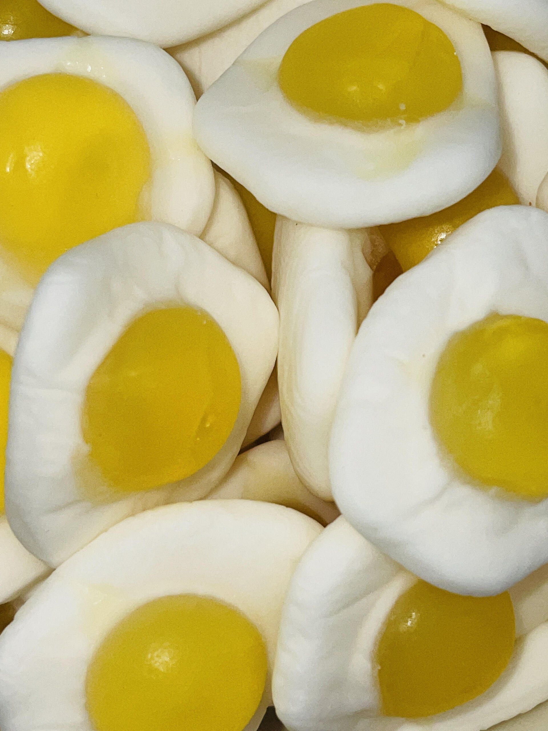 A pile of gummy eggs with yellow yolks