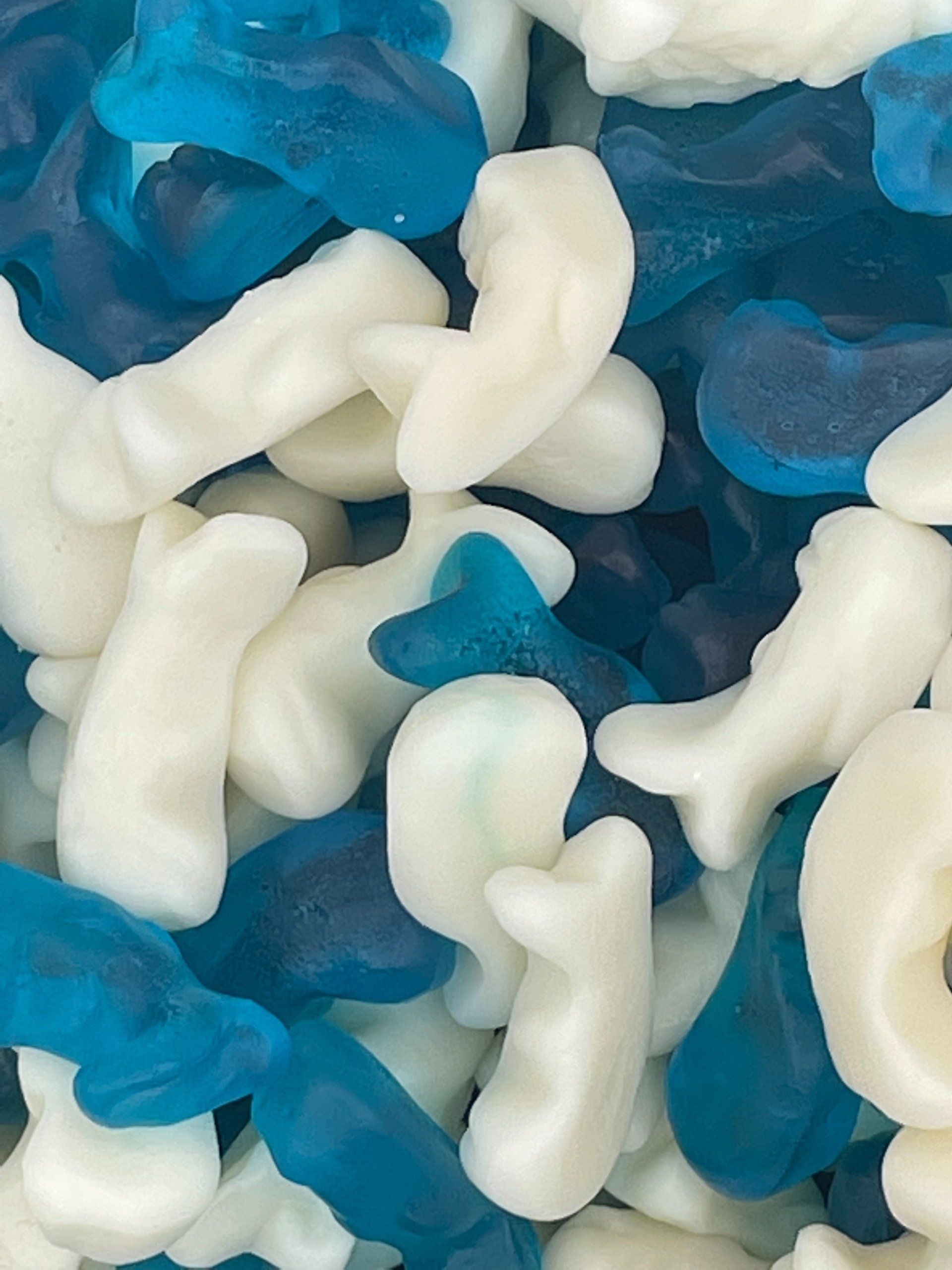 A pile of blue and white gummy whales