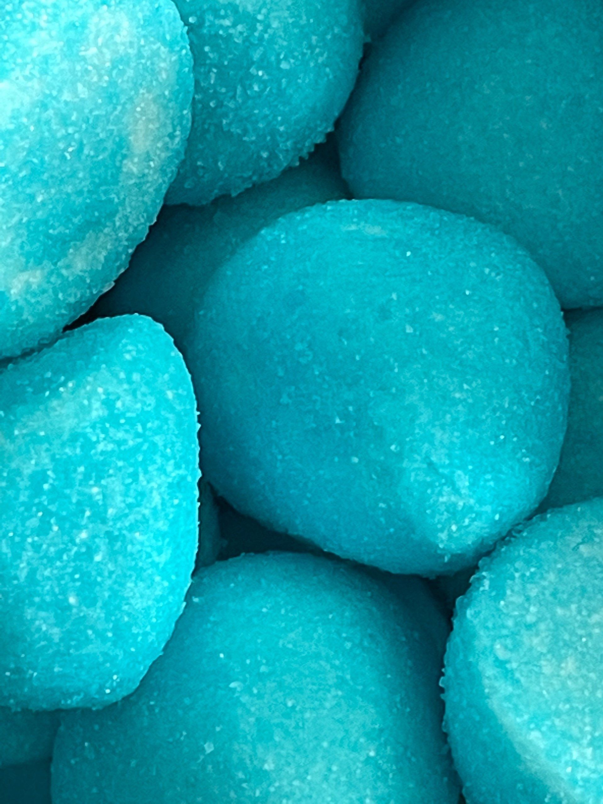 A close up of a pile of blue candy