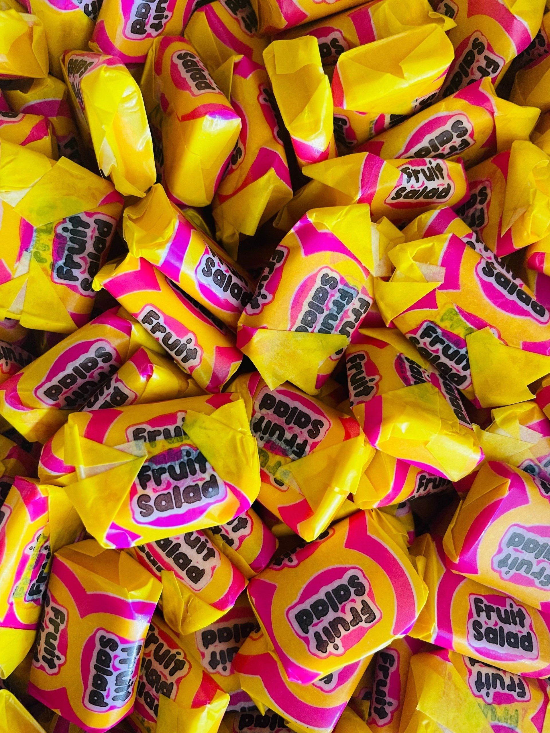 A pile of yellow and pink fruit salad candy.