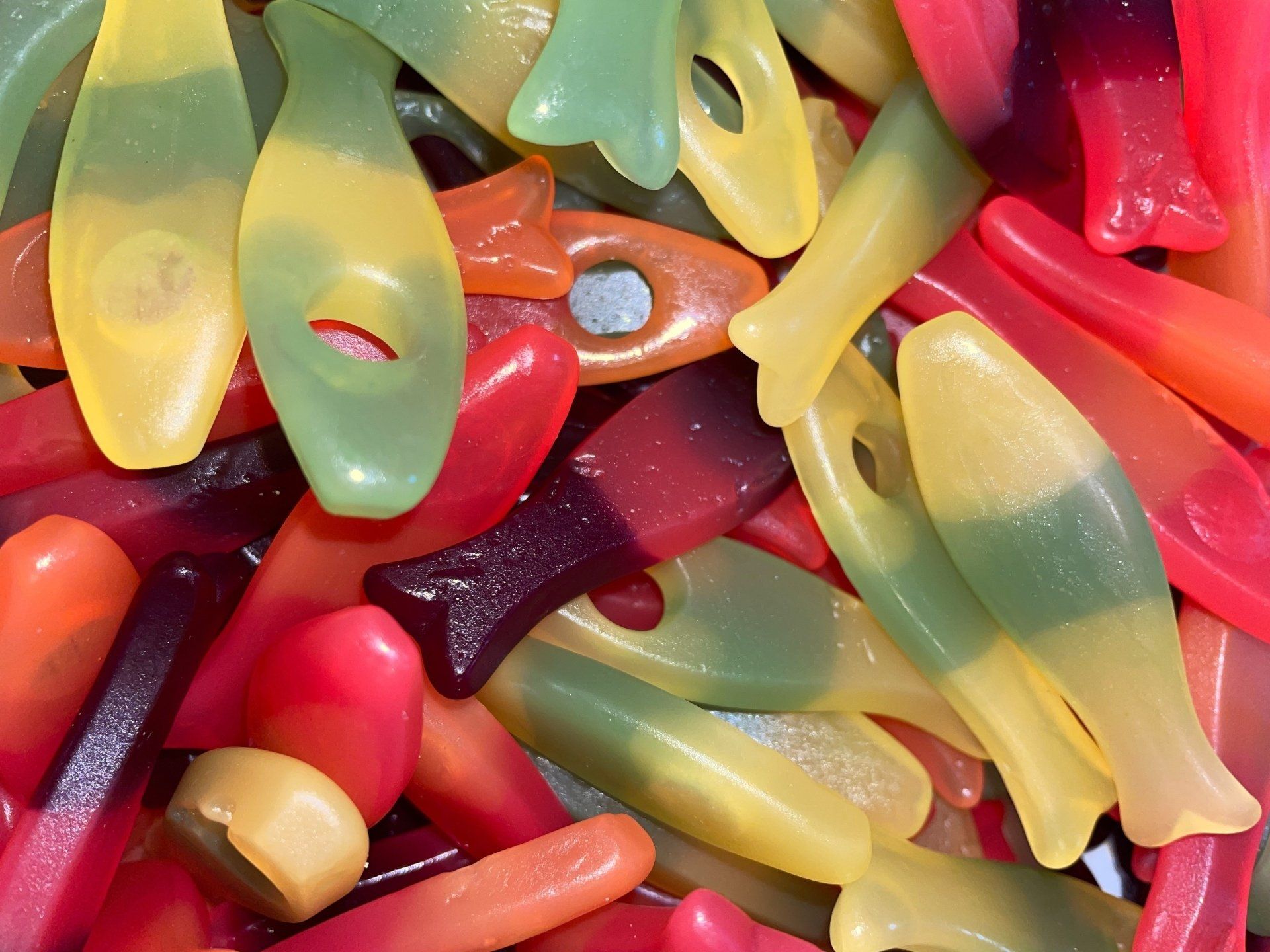 A pile of colorful gummy fish shaped candies