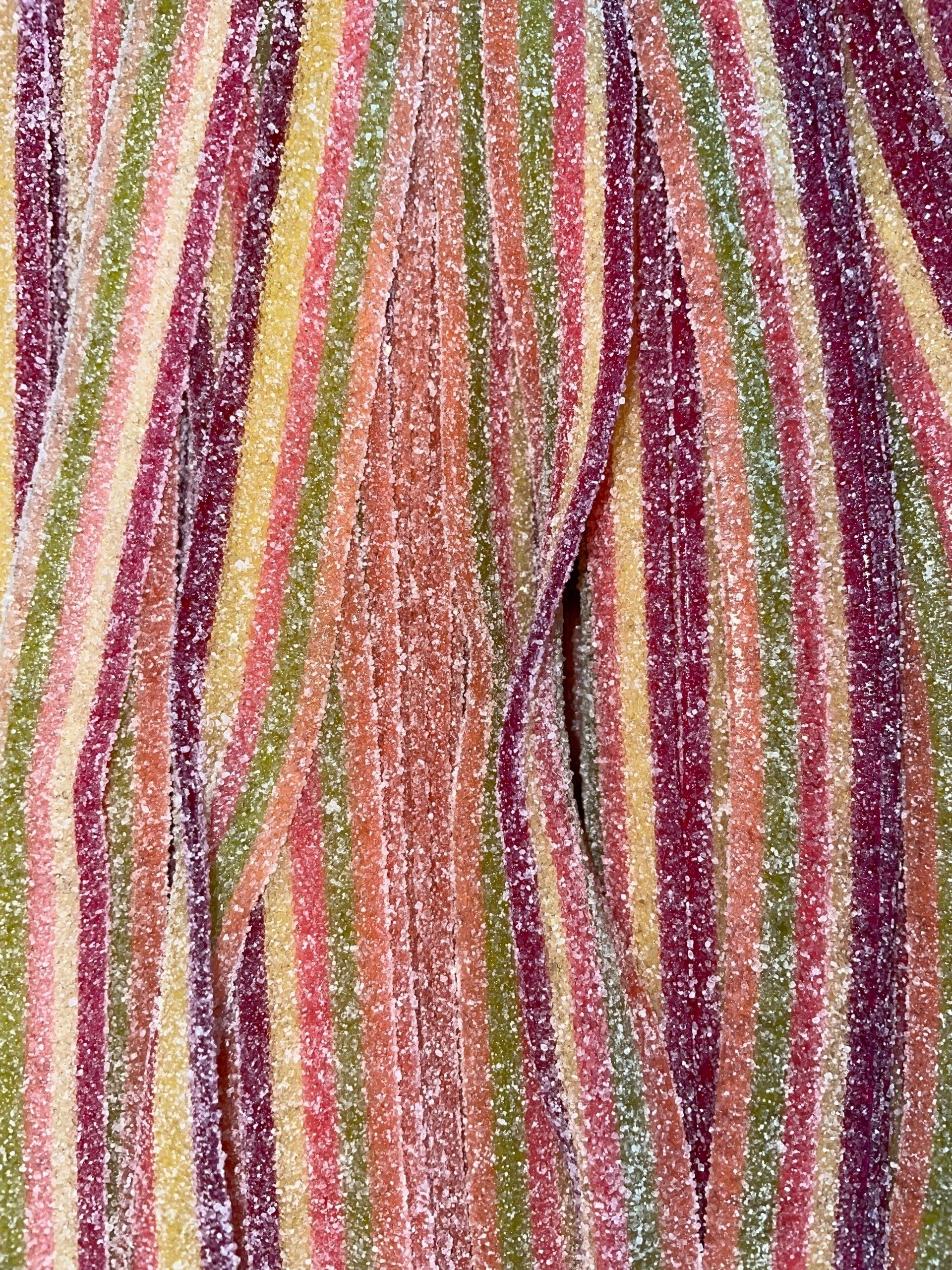 A close up of a bunch of colorful candy sticks.