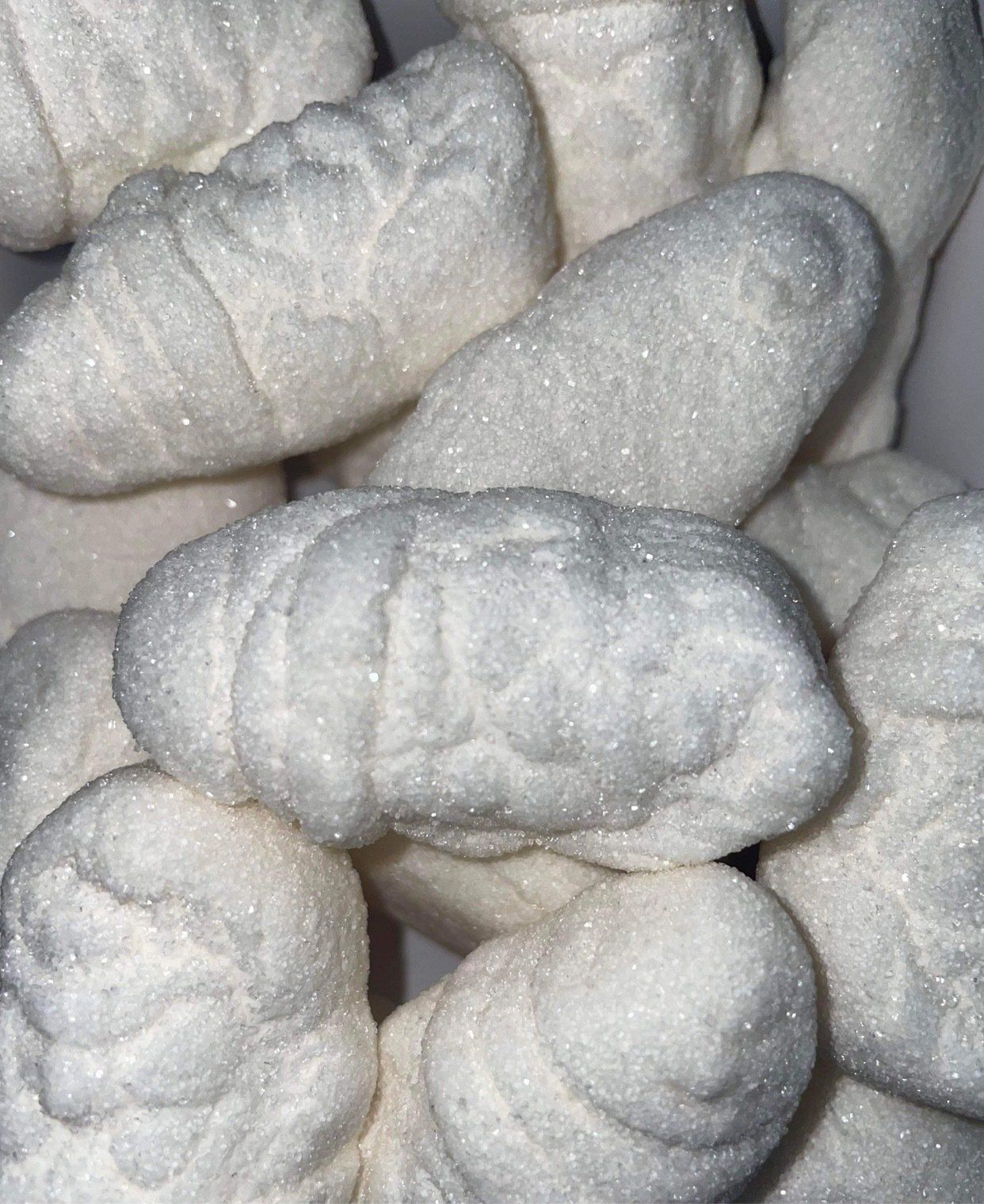 A close up of a pile of white marshmallows