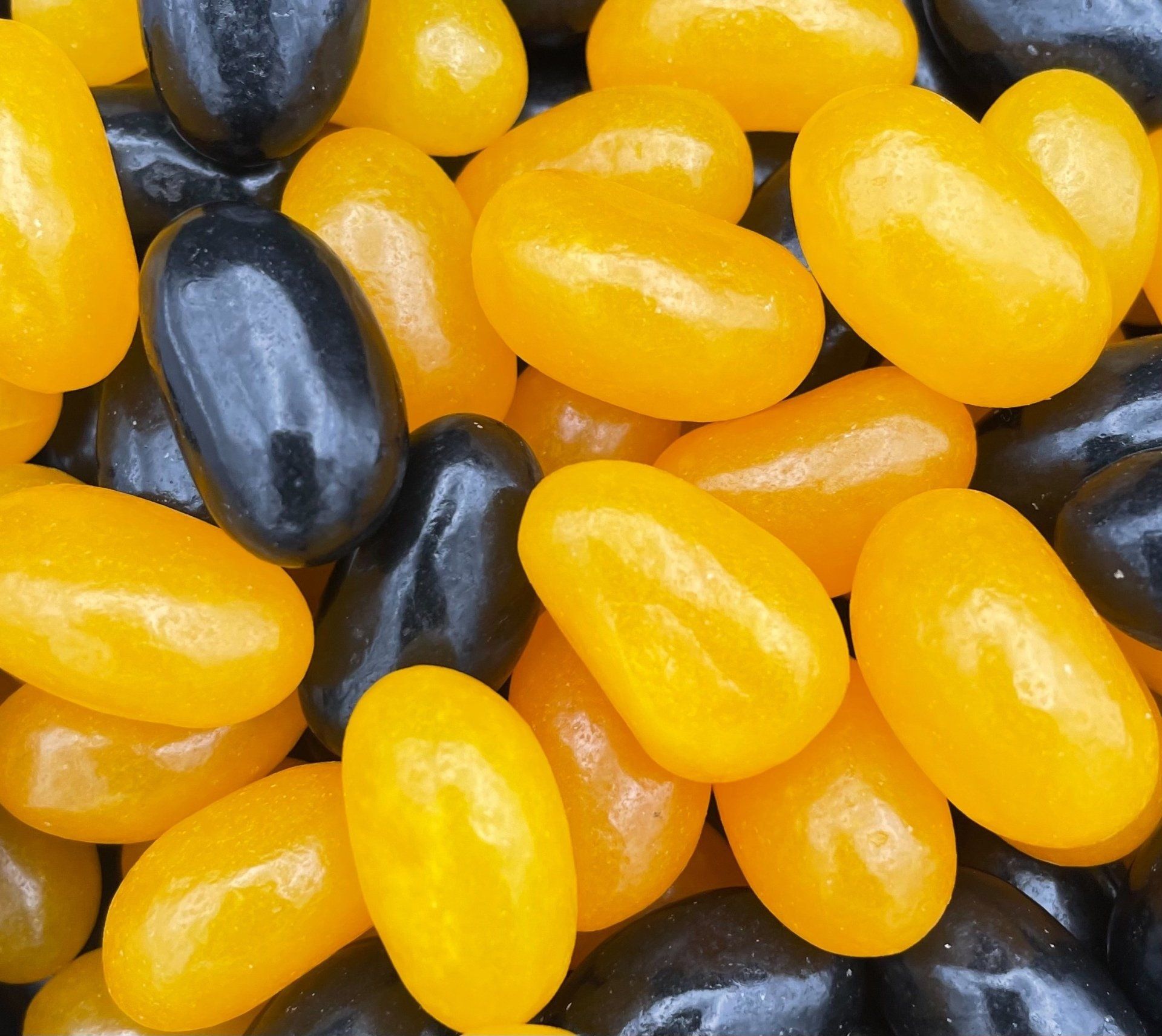 A pile of yellow and black jelly beans