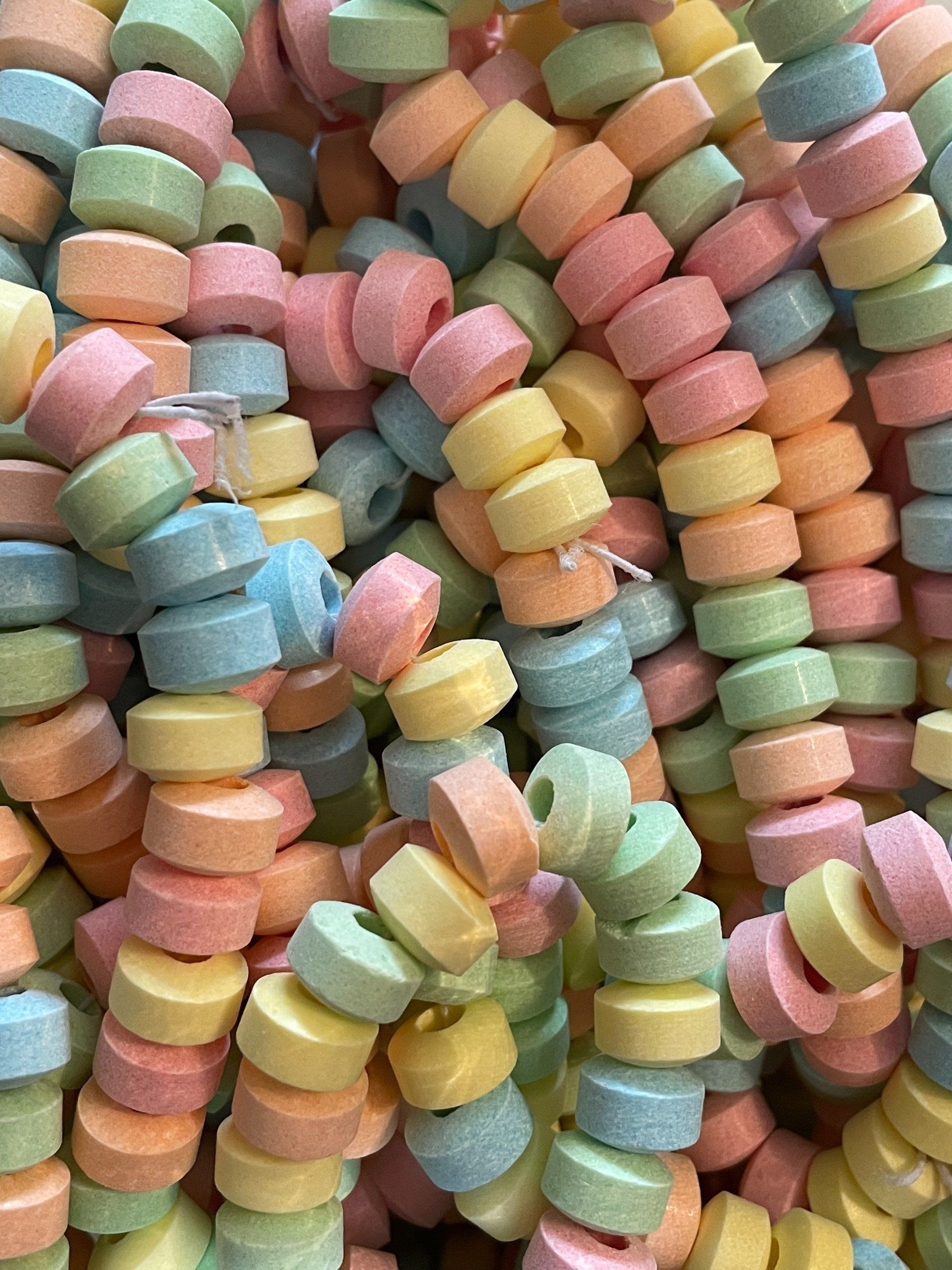 A bunch of colorful candy beads are stacked on top of each other.