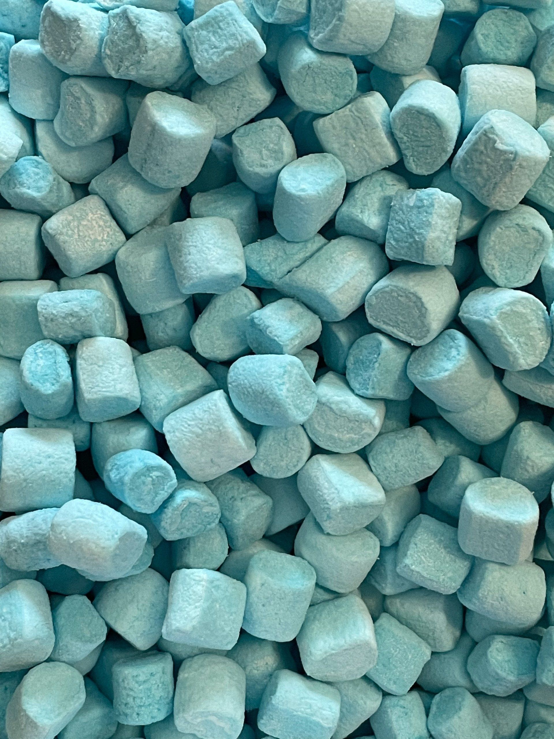 A pile of blue marshmallows are stacked on top of each other.