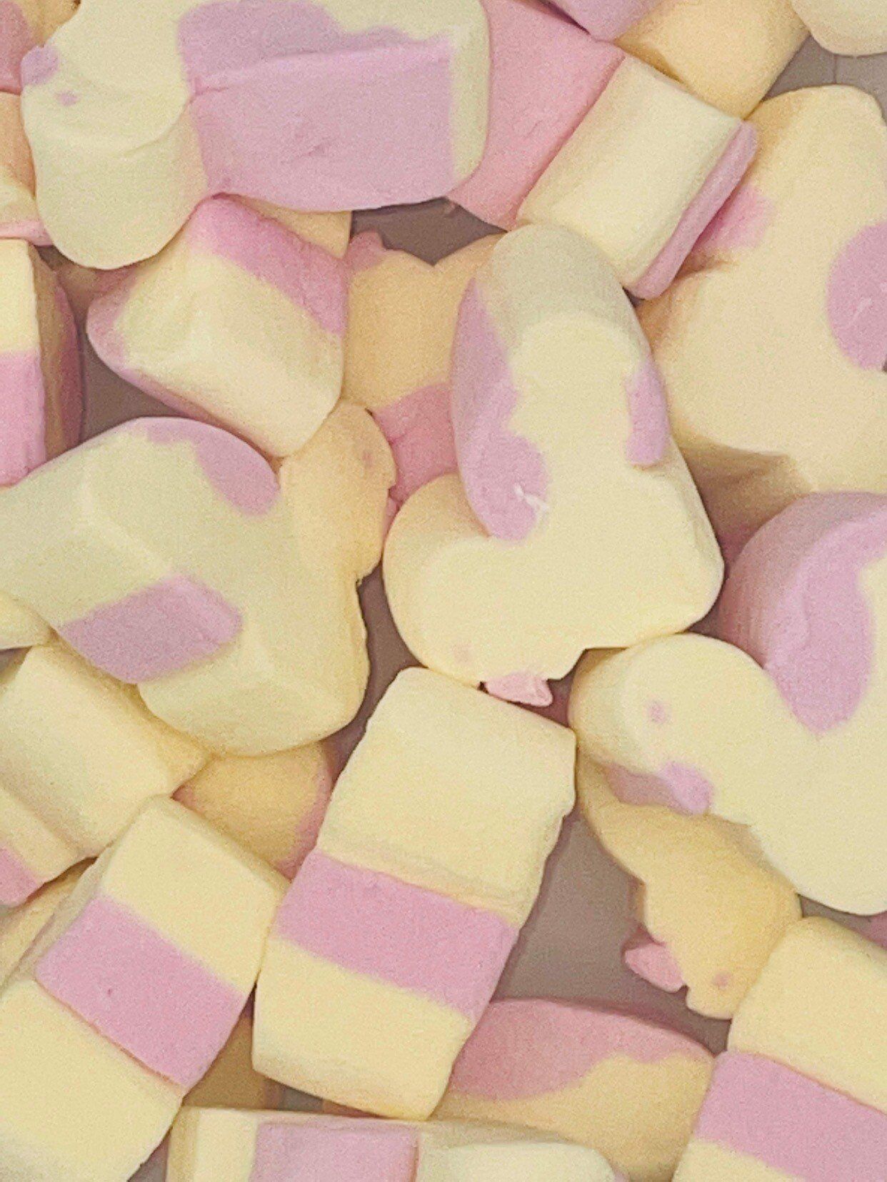 A pile of white and pink marshmallows in the shape of hearts