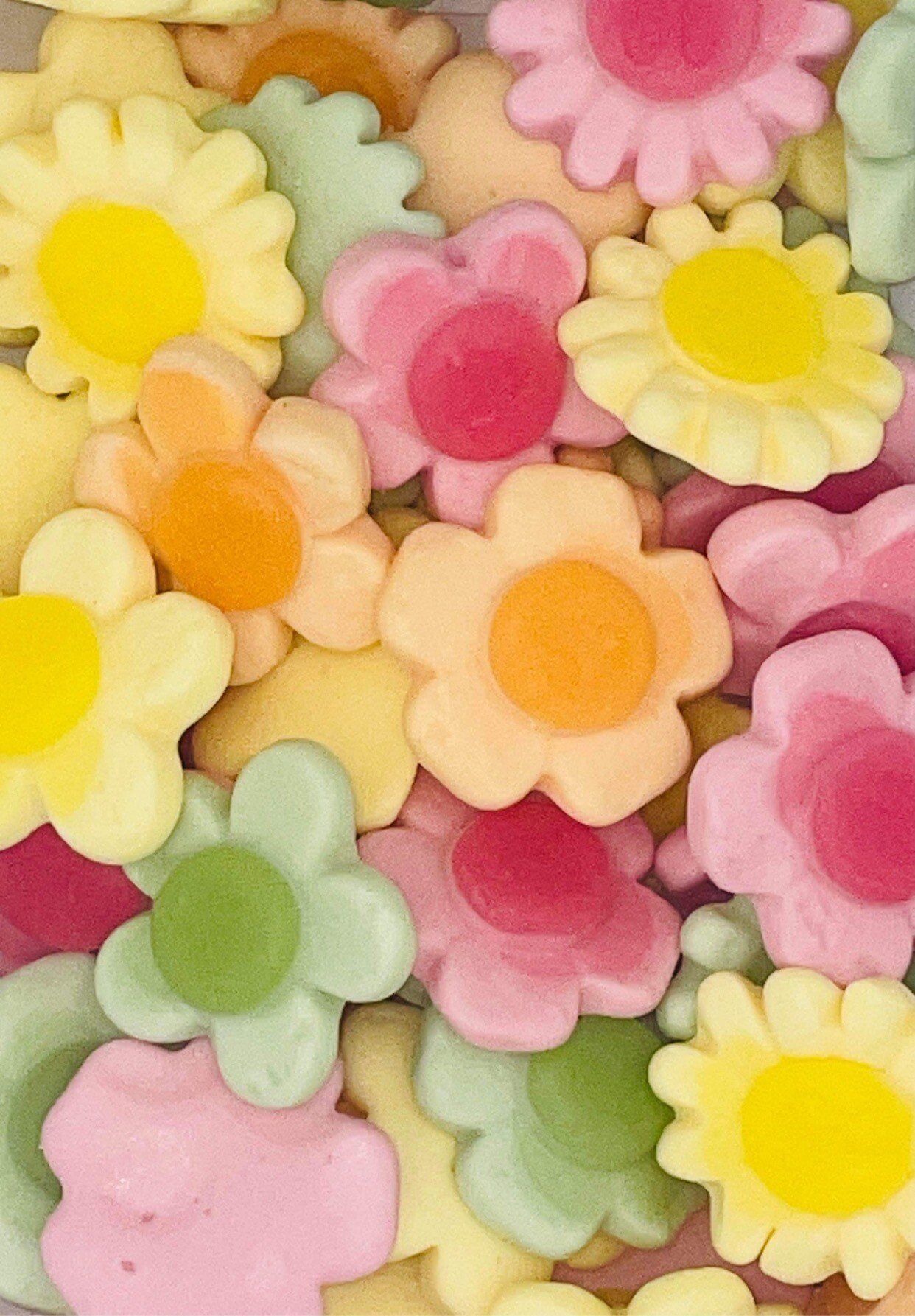 A pile of colorful flowers with a yellow center