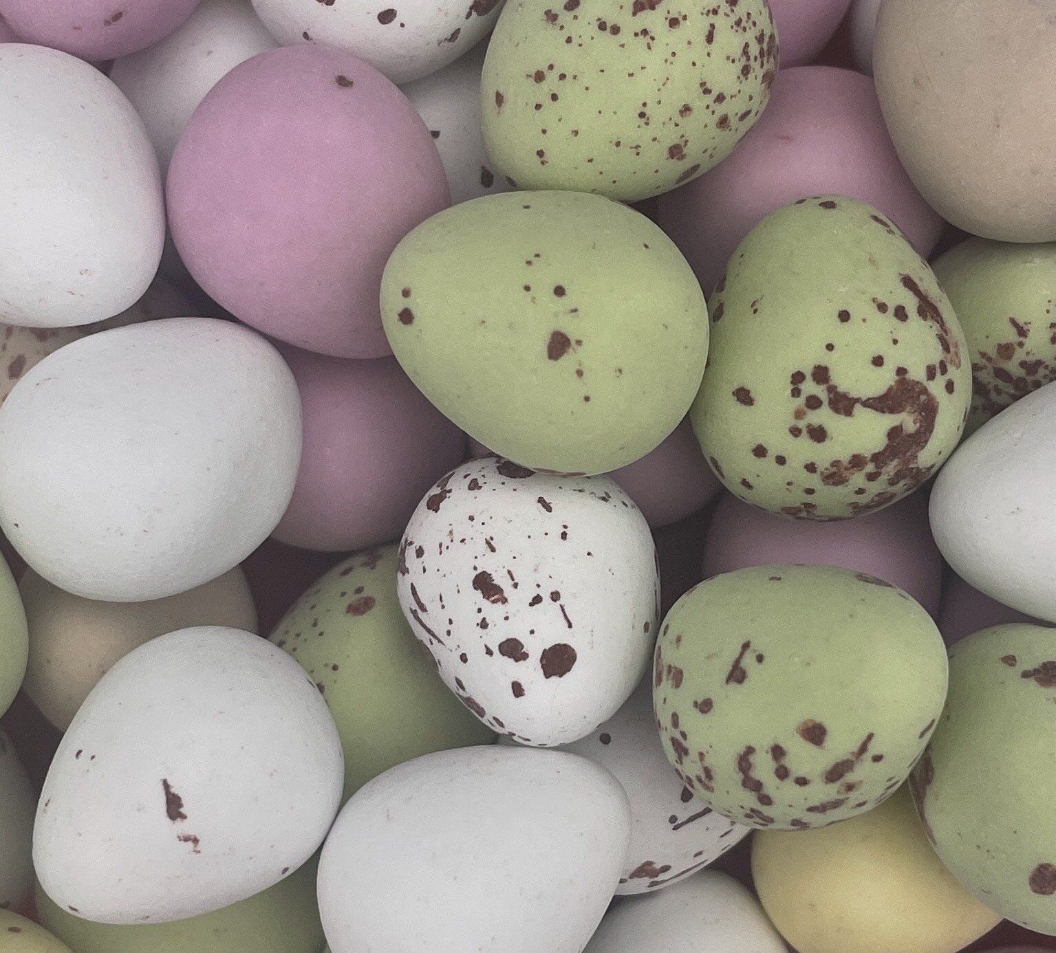 A bunch of eggs are stacked on top of each other