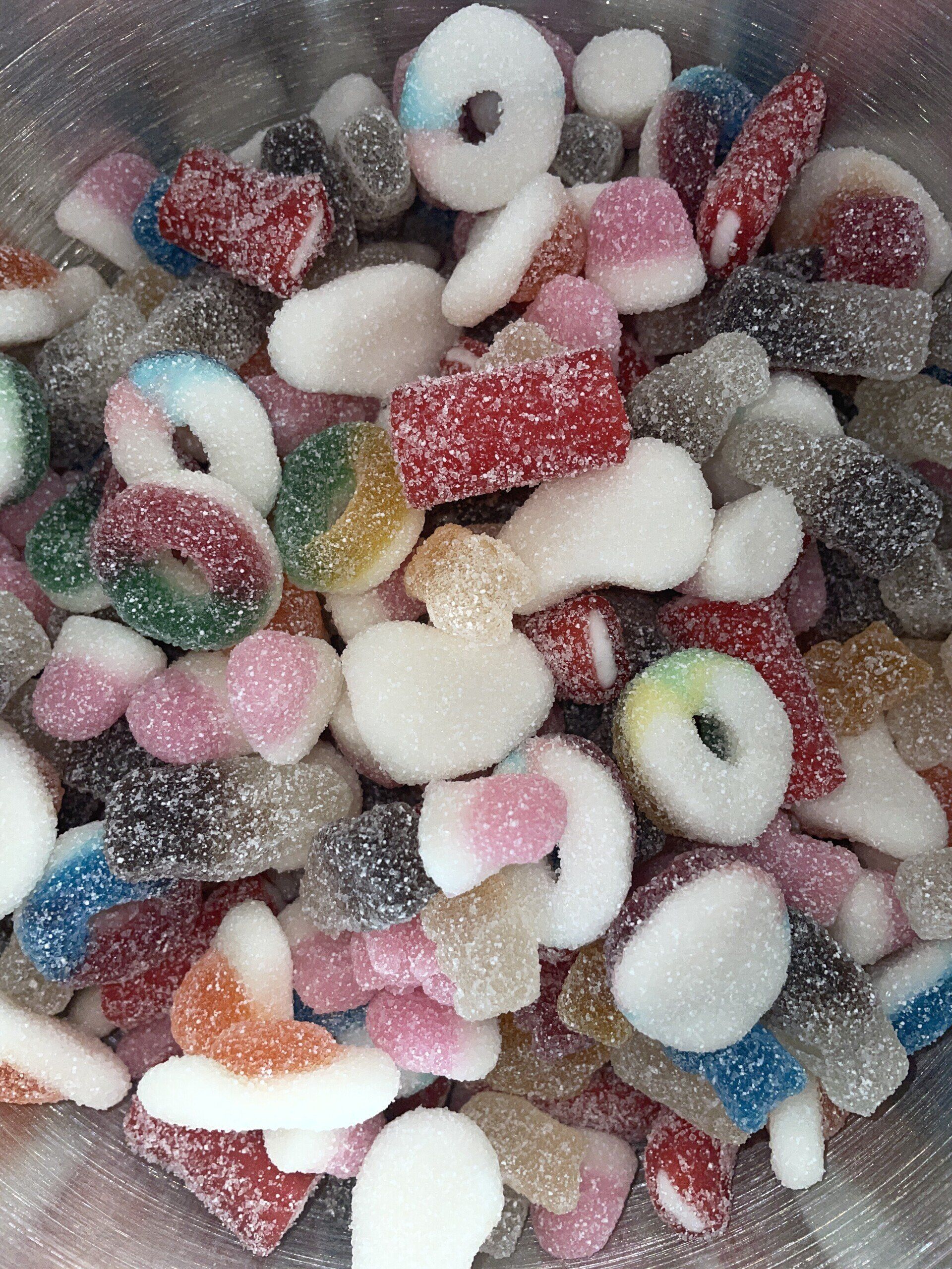 A bowl filled with a variety of gummy candies