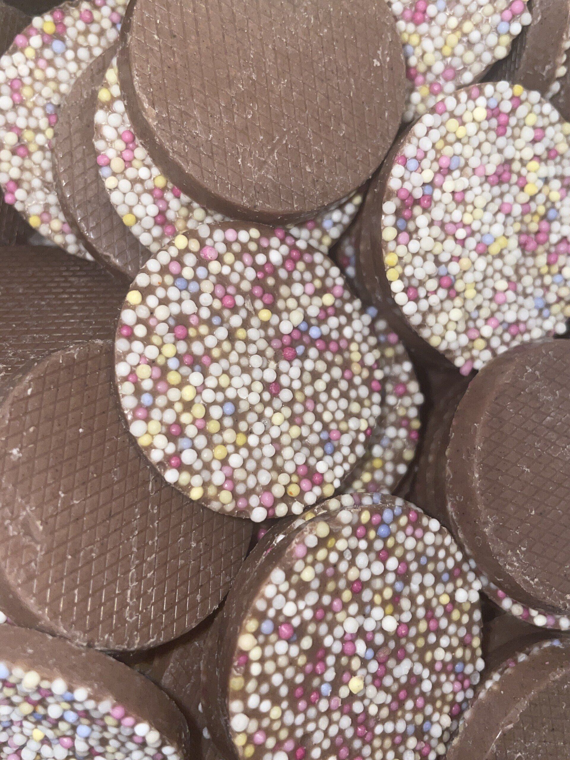 A pile of chocolate coins with sprinkles on them