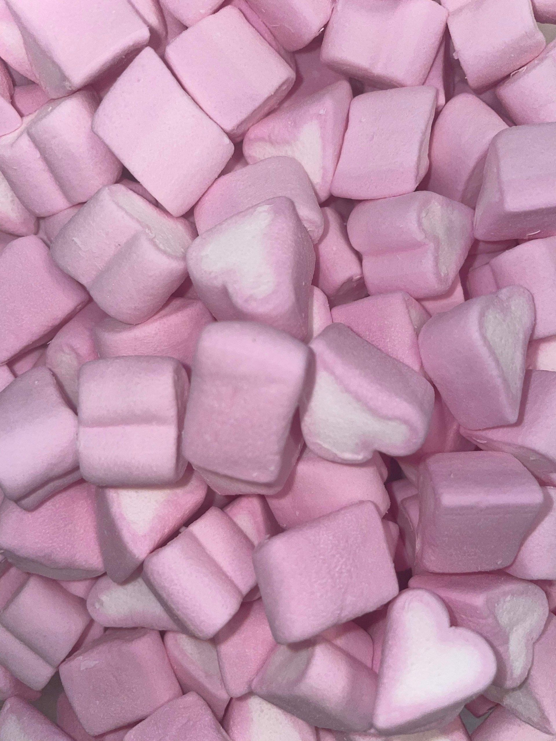 A pile of pink and white marshmallows in the shape of hearts.