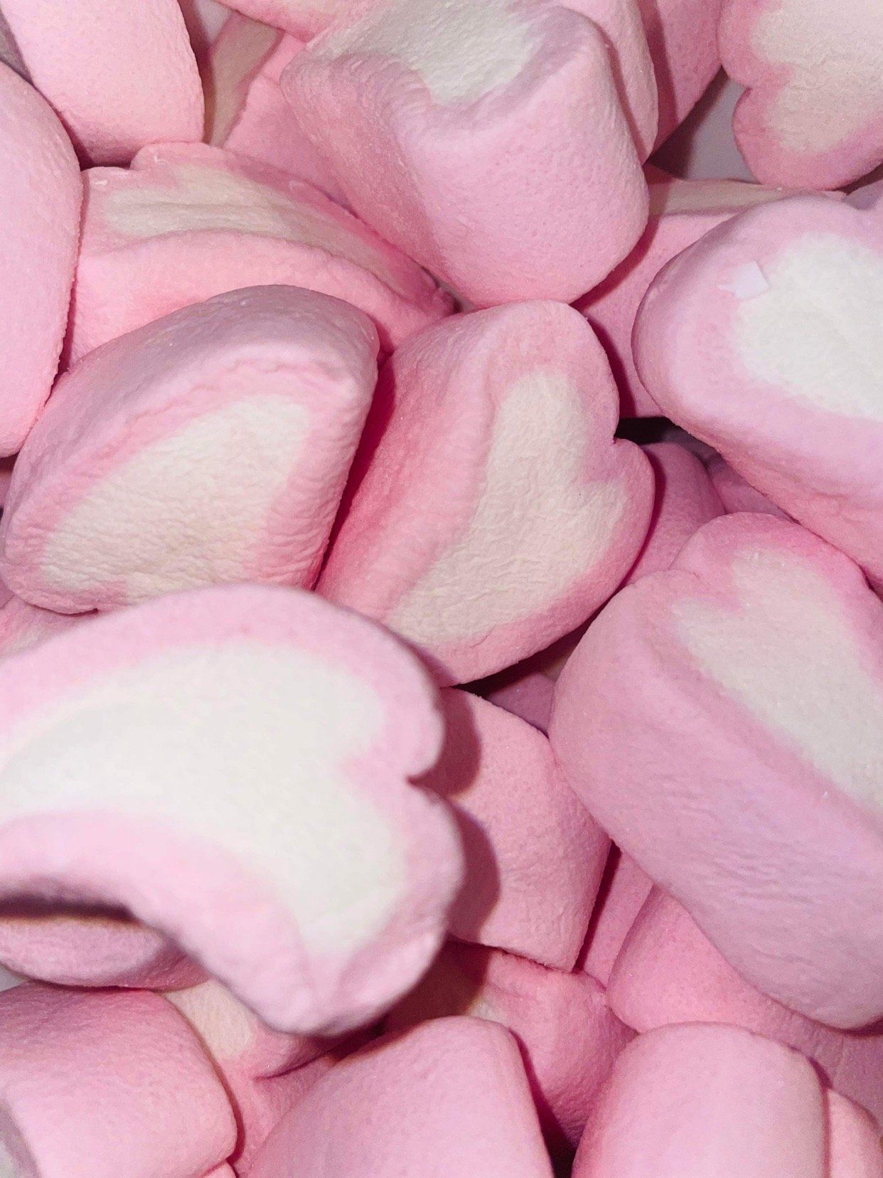 A pile of pink and white marshmallows in the shape of hearts