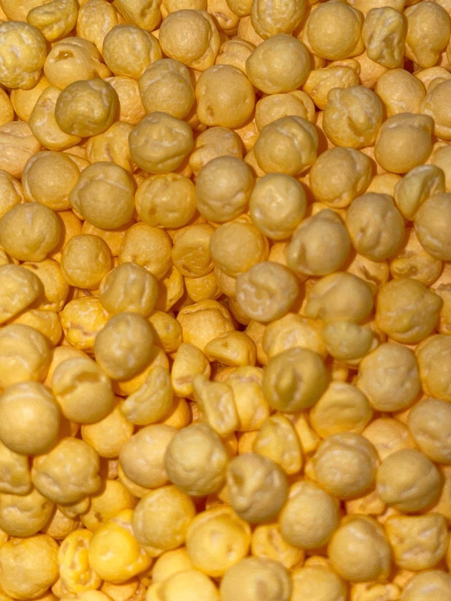 A close up of a pile of chickpeas on a table.