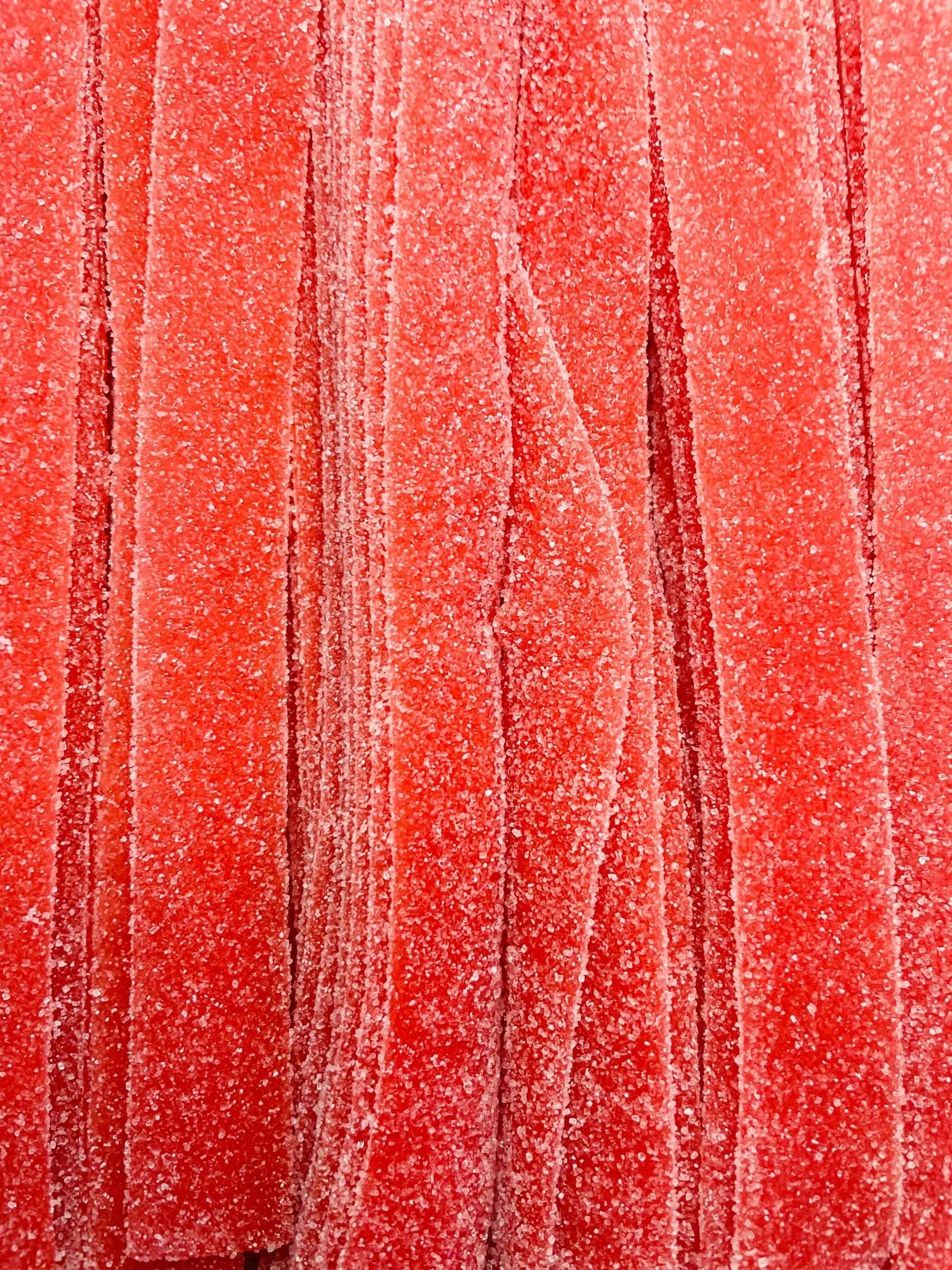 A close up of a red candy that looks like a watermelon.