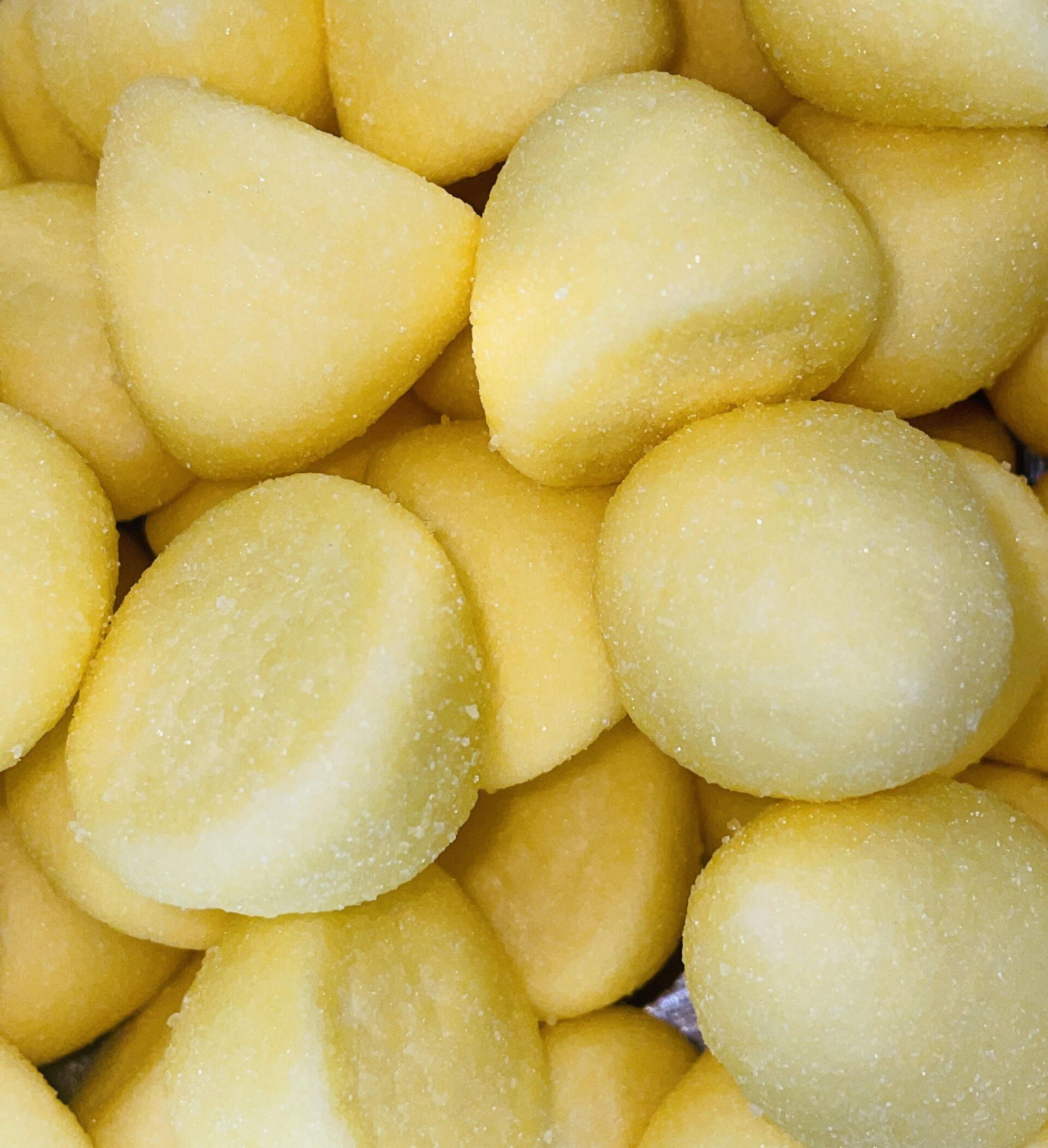 A close up of a pile of yellow potatoes