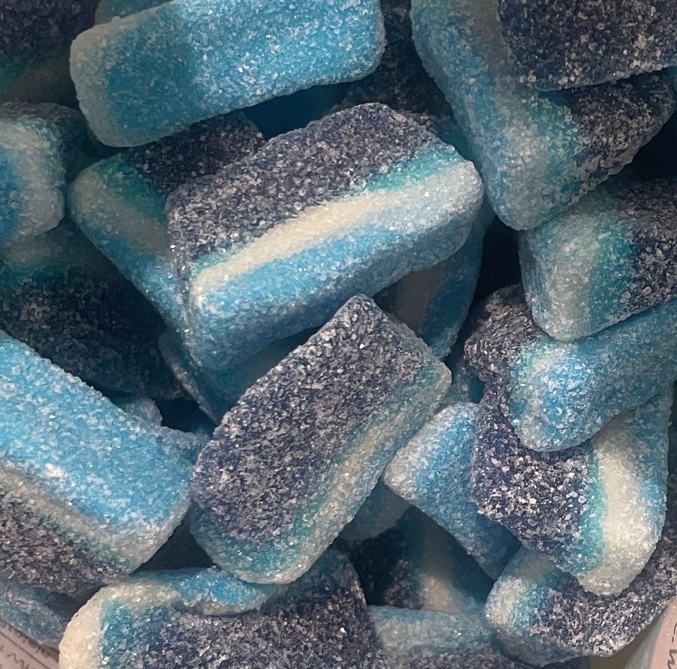 A pile of blue and white gummy candies