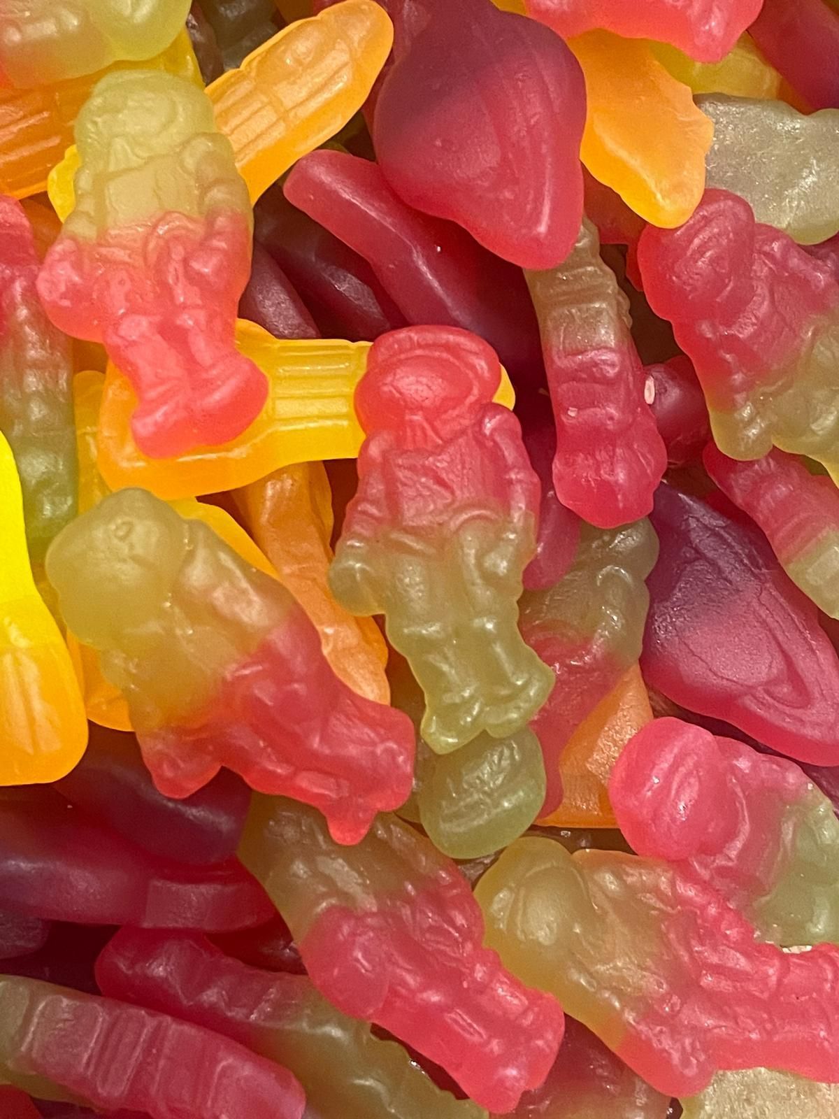 A close up of a pile of gummy worms in different colors.
