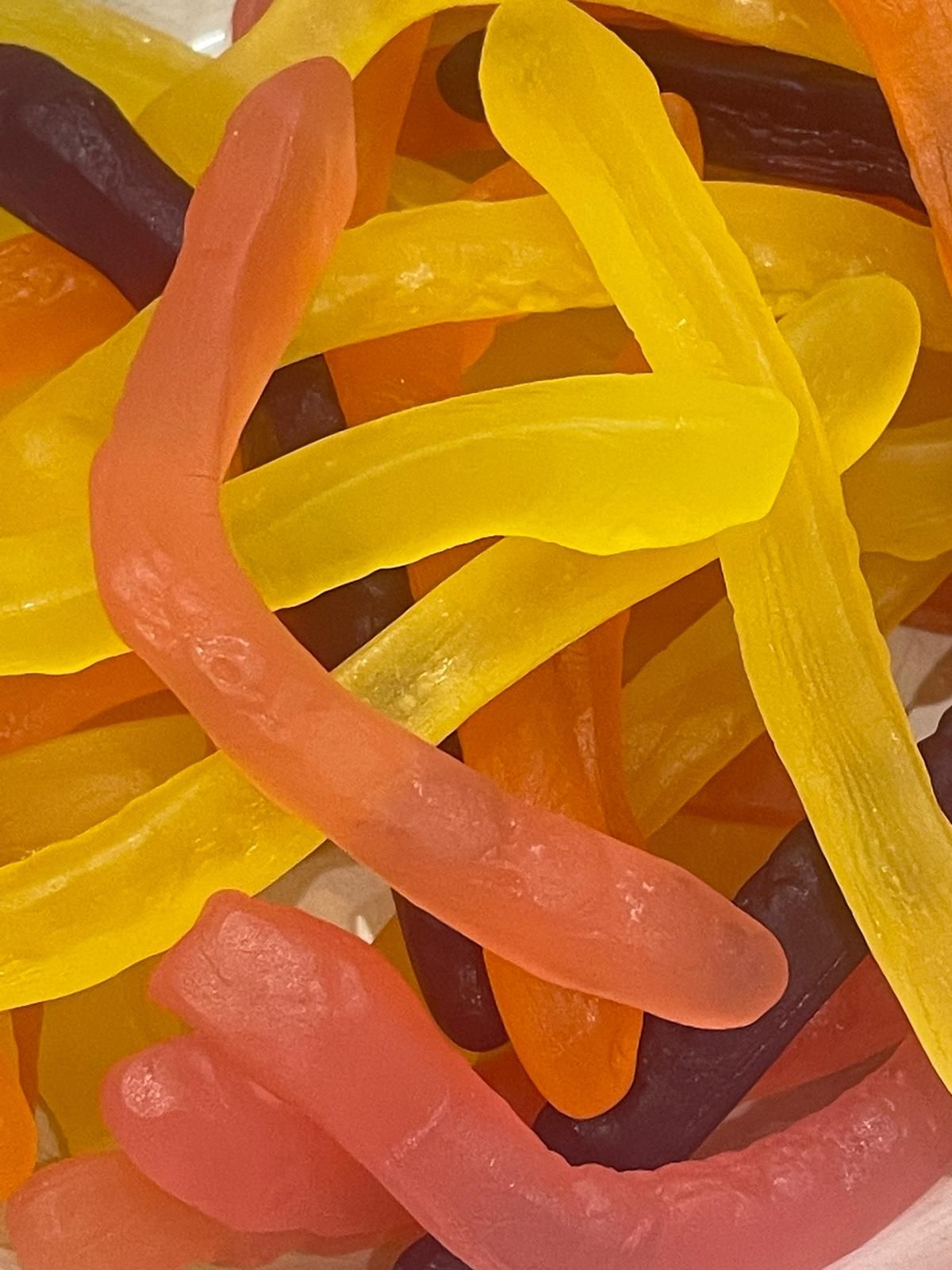 A close up of a pile of colorful gummy snakes
